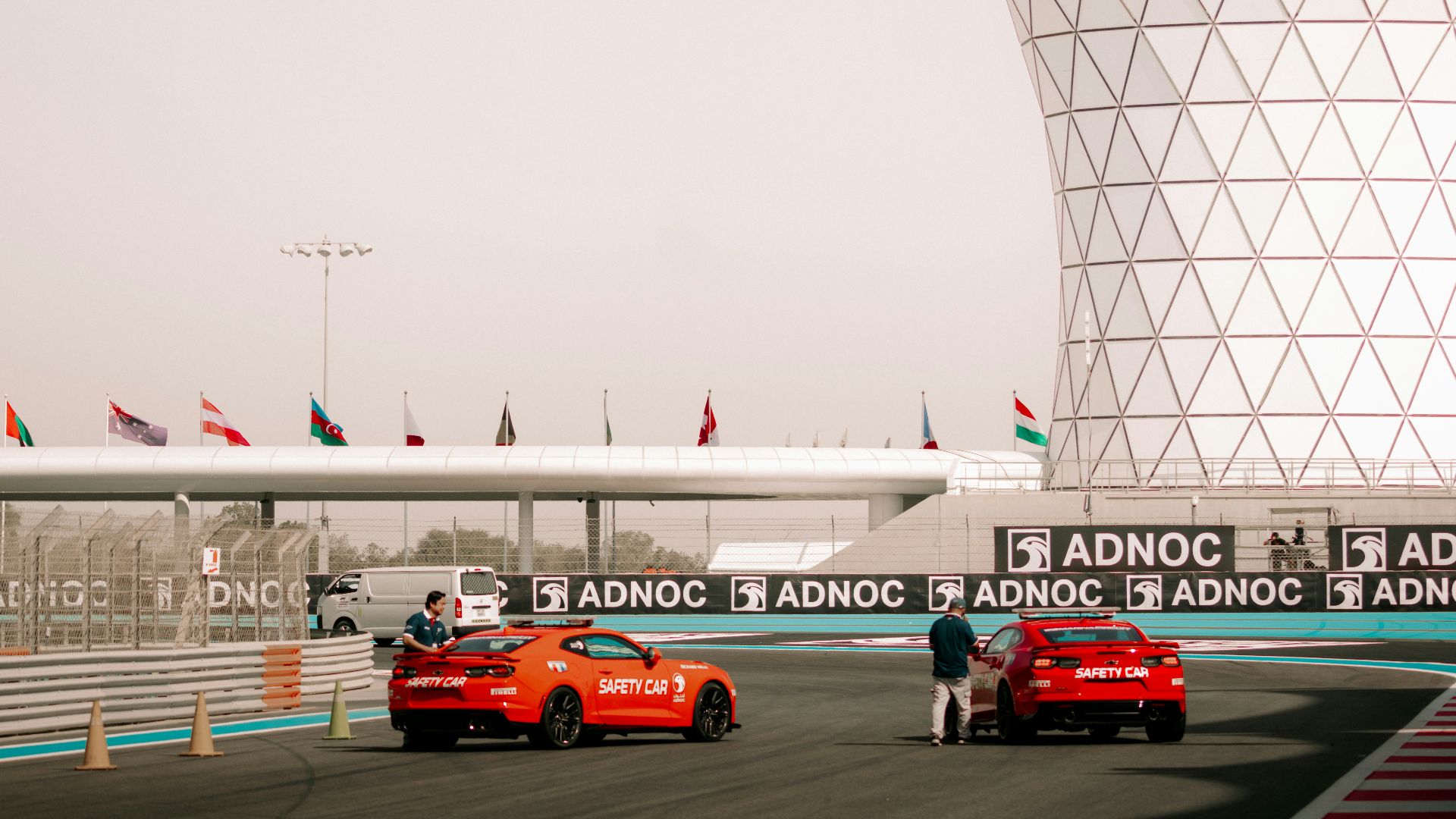 a group of cars driving down a race track
