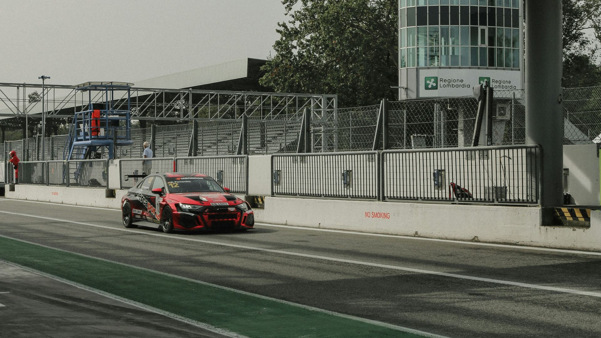 a car driving down a road under a bridge
