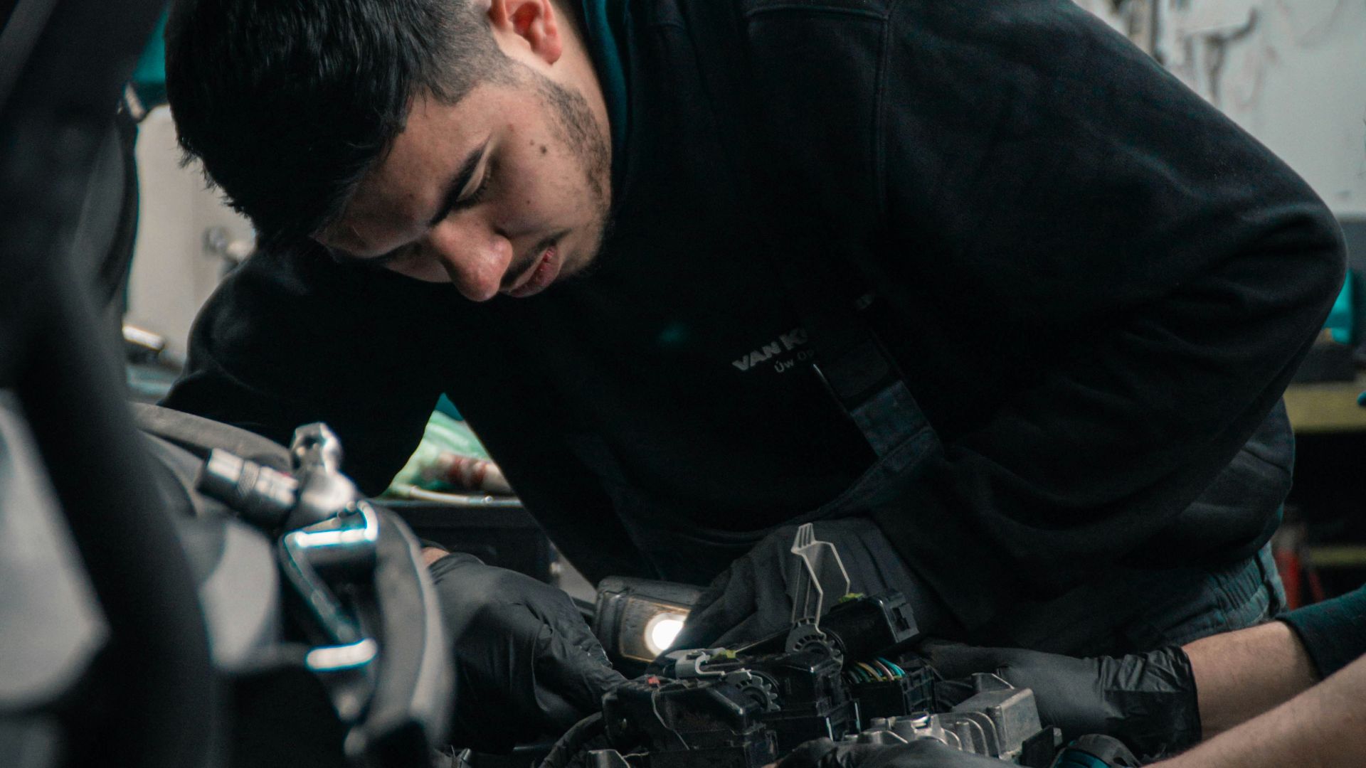 man in black jacket and blue denim jeans riding motorcycle