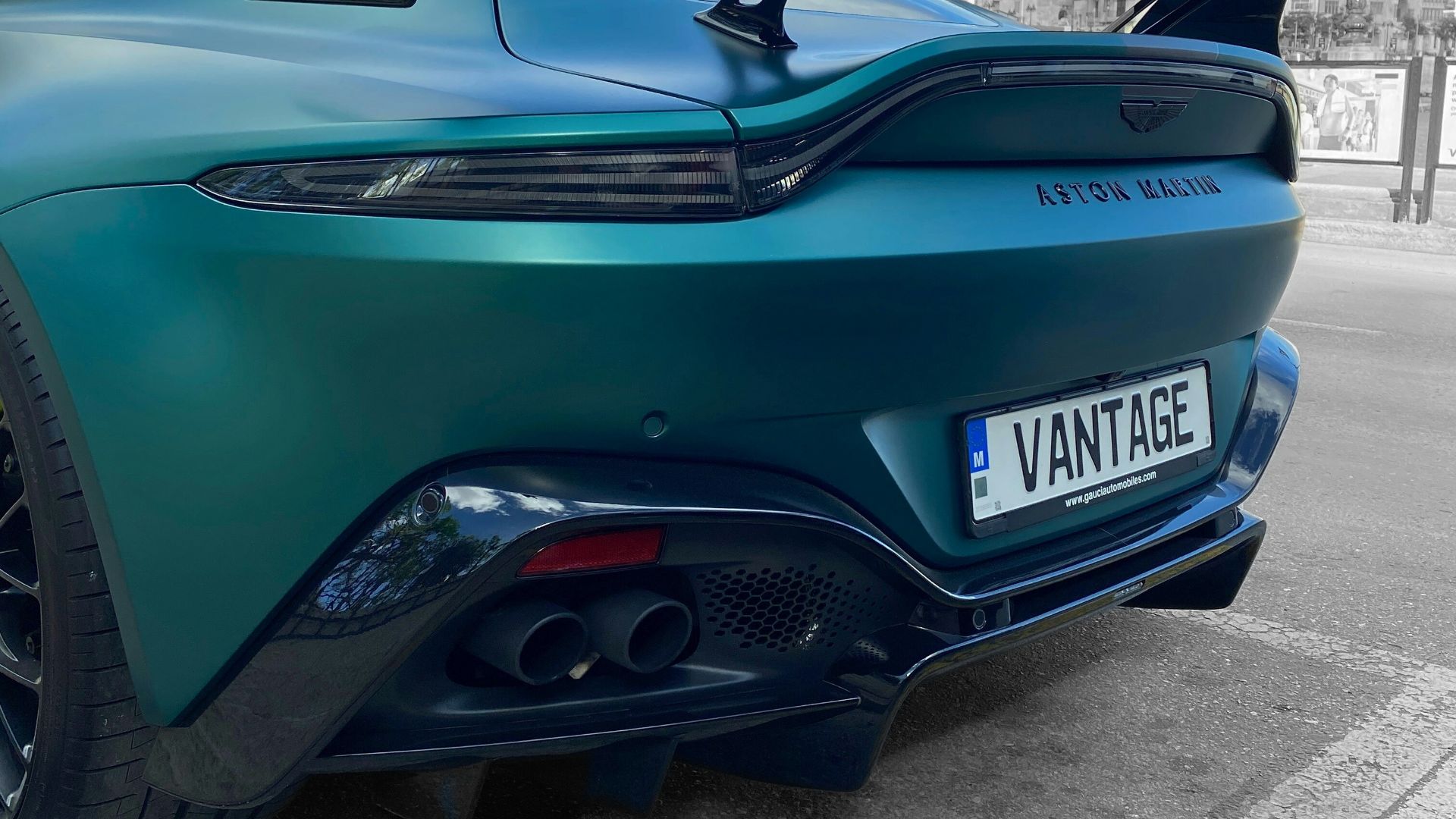 a blue sports car parked on the side of the road