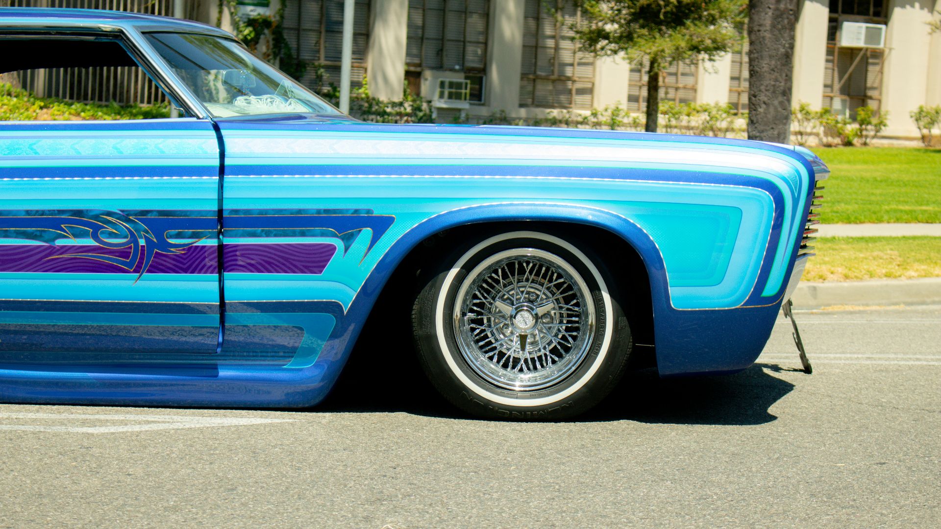 a blue car parked on the side of the road