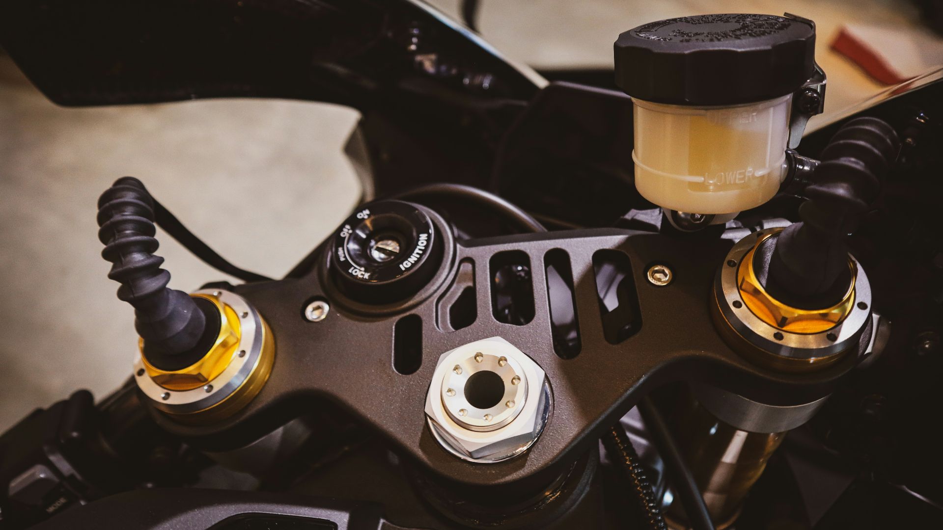 Close-up of a motorcycle's front suspension and handlebars.