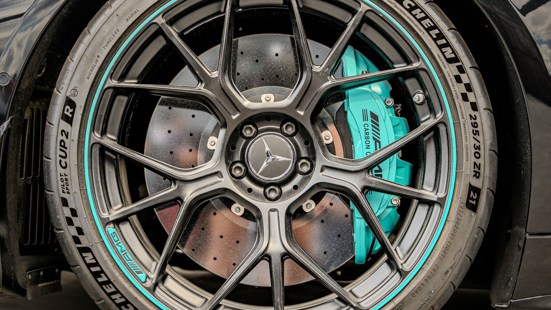 A black mercedes car wheel shows detail.