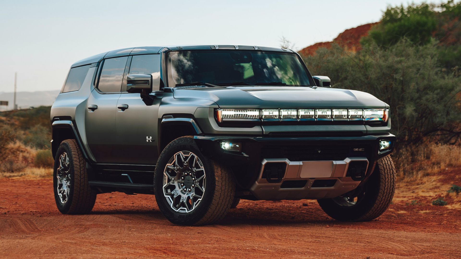 A silver truck parked on a dirt road