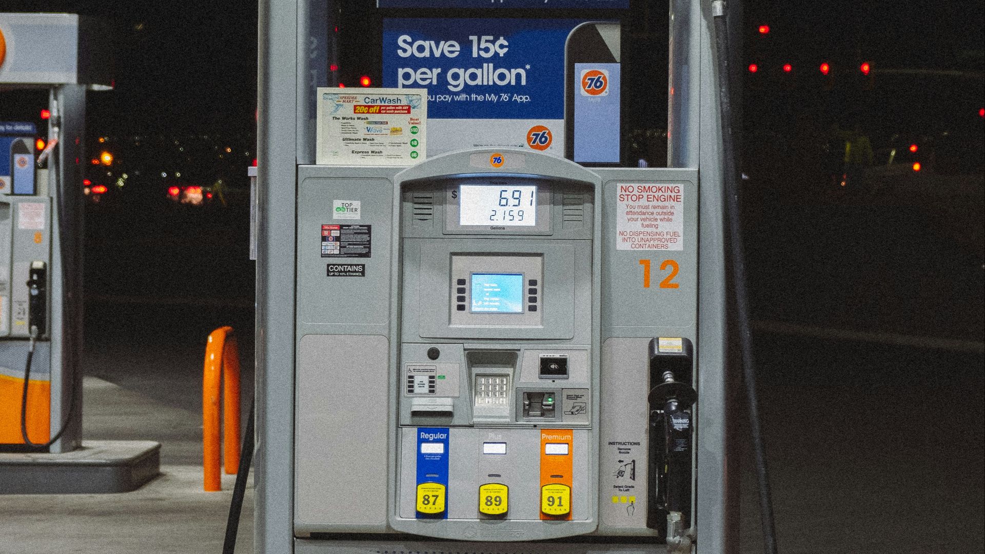 gray and orange gasoline pump