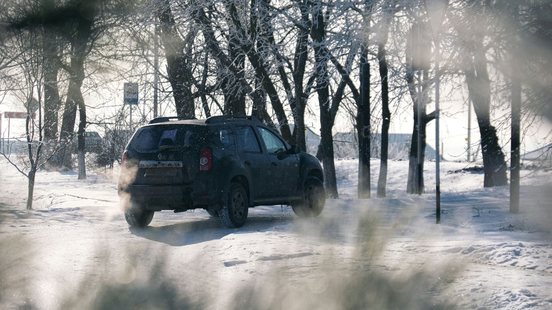 A car driving down a snow covered road