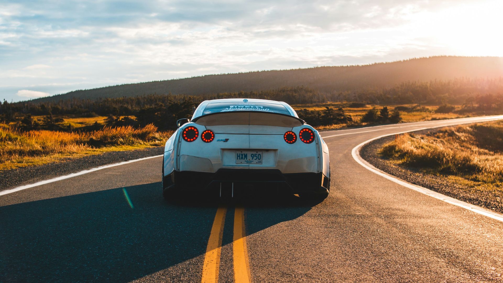 silver sports coupe on asphalt road