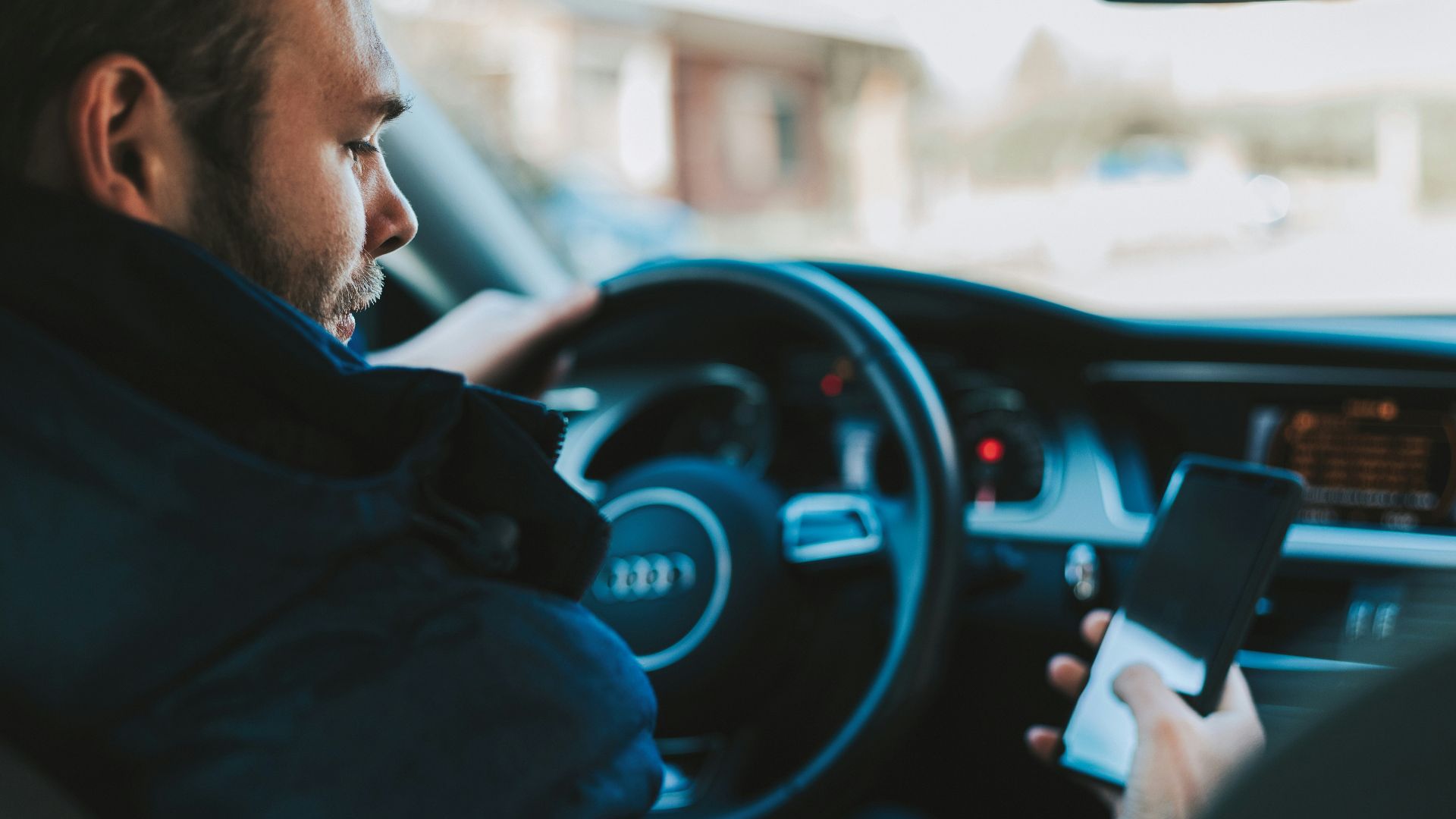 man holding black smartphone