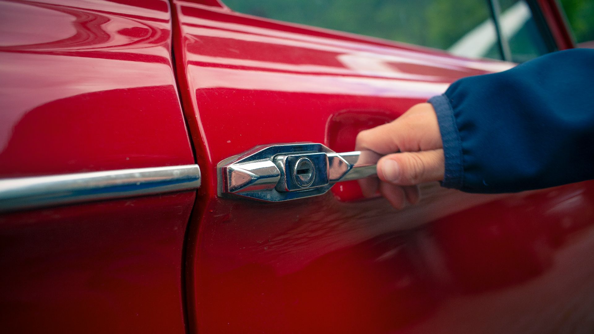 person holding car door