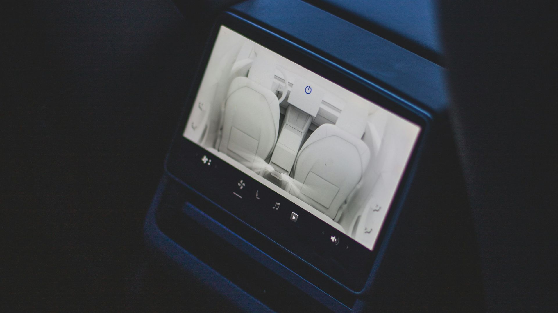 a car dashboard with a screen showing a car's interior