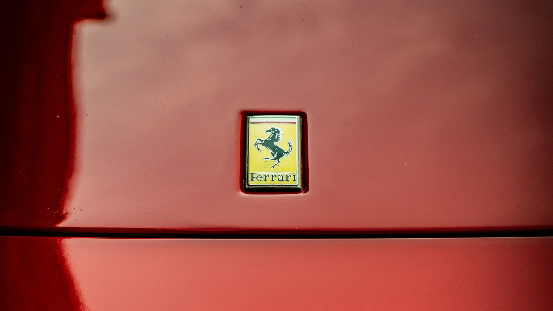 Red ferrari emblem on a car hood