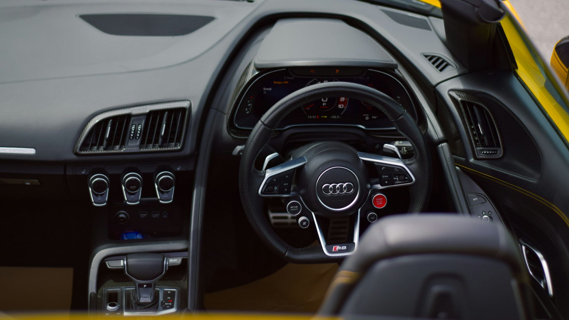the interior of a yellow and black sports car