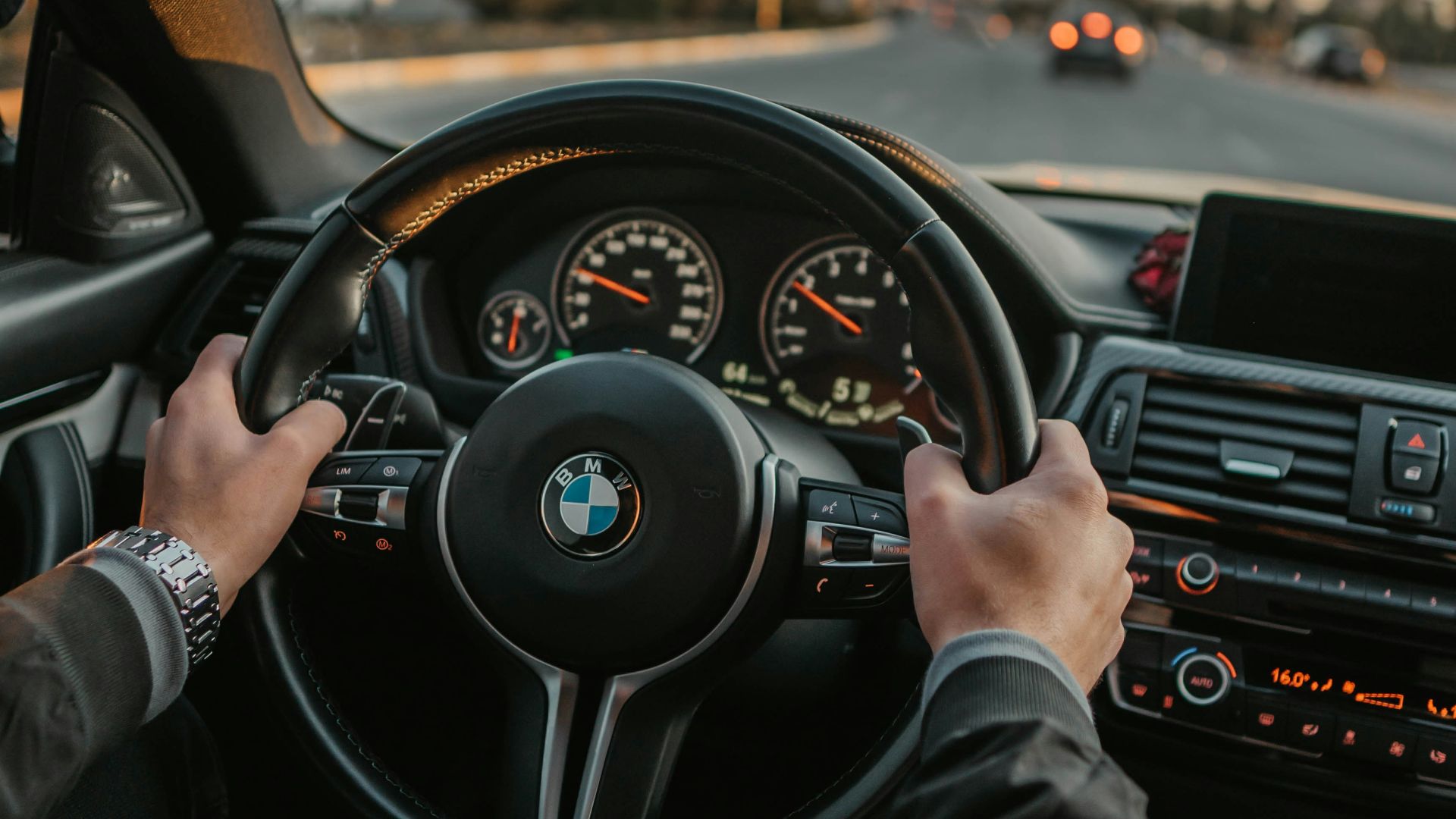 unknown person driving BMW car