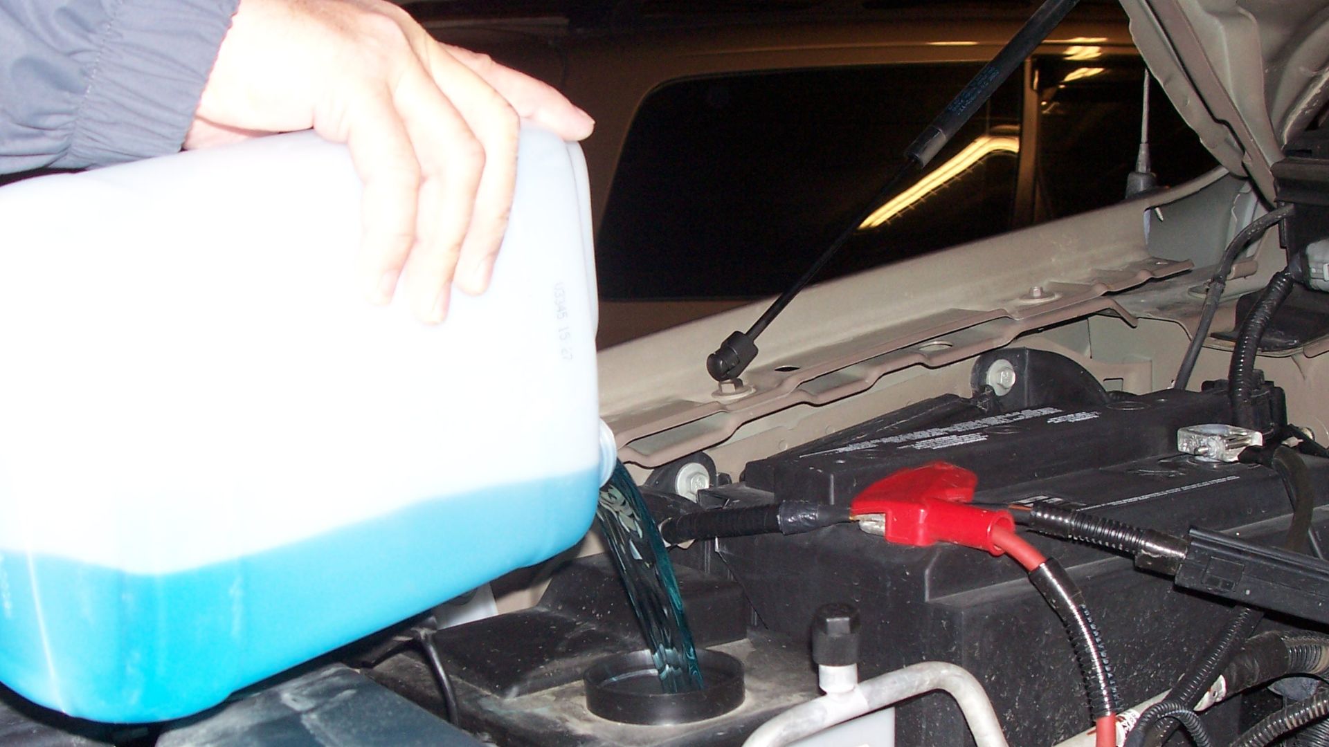 File:Man pouring windshield washer fluid.jpg