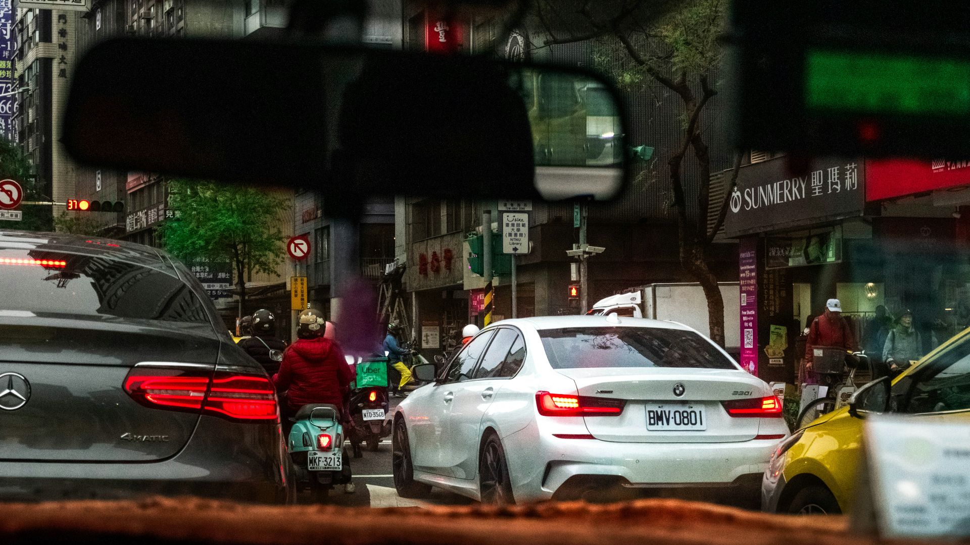 Cars and scooter in city traffic jam