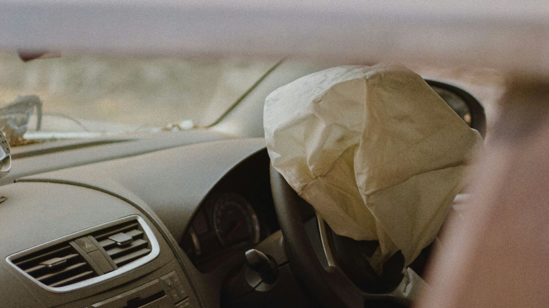 a car with a paper bag in the passenger seat
