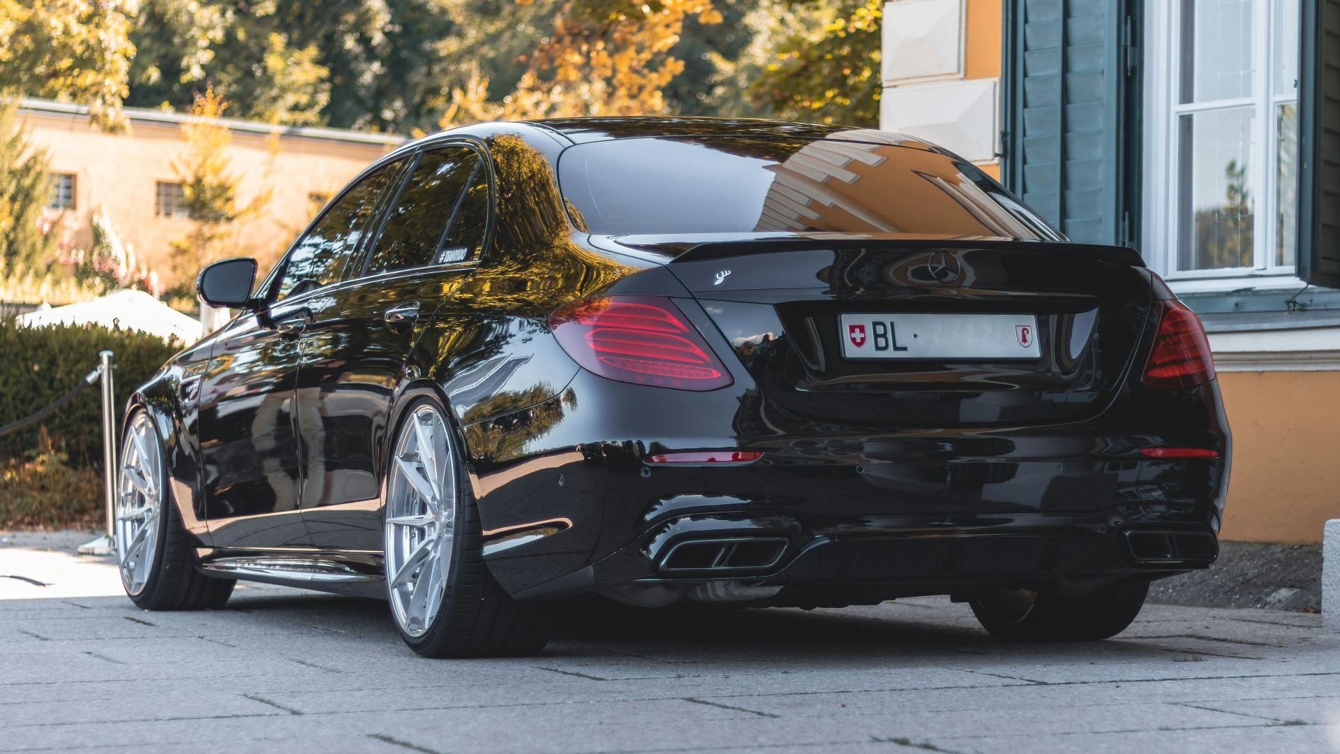 a black car parked in front of a building