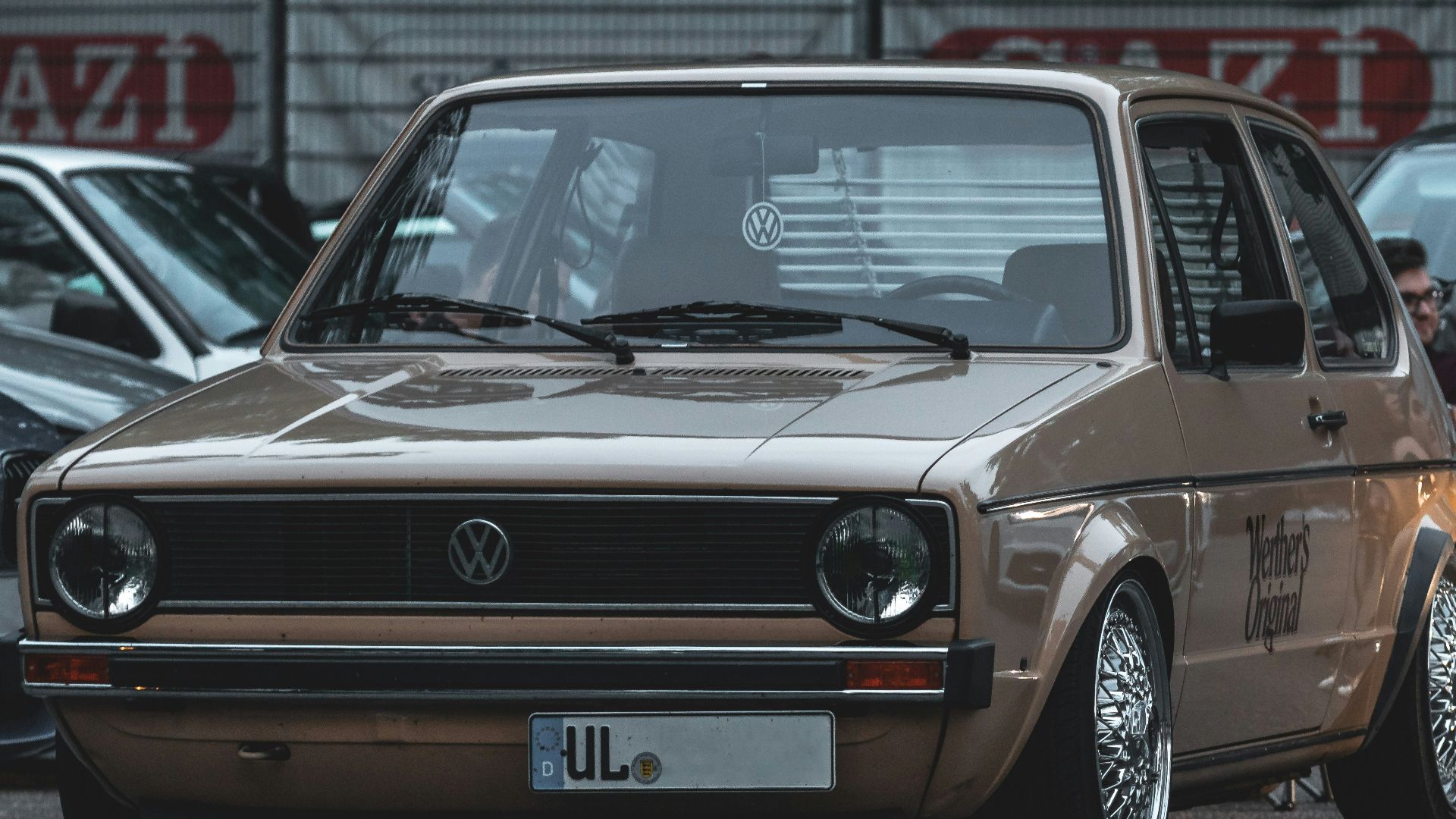 a group of people sitting around a parked car
