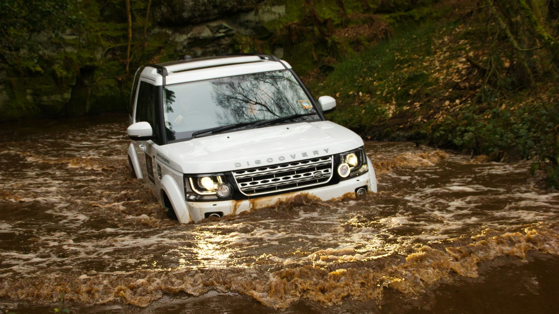 white nissan car on dirt road during daytime