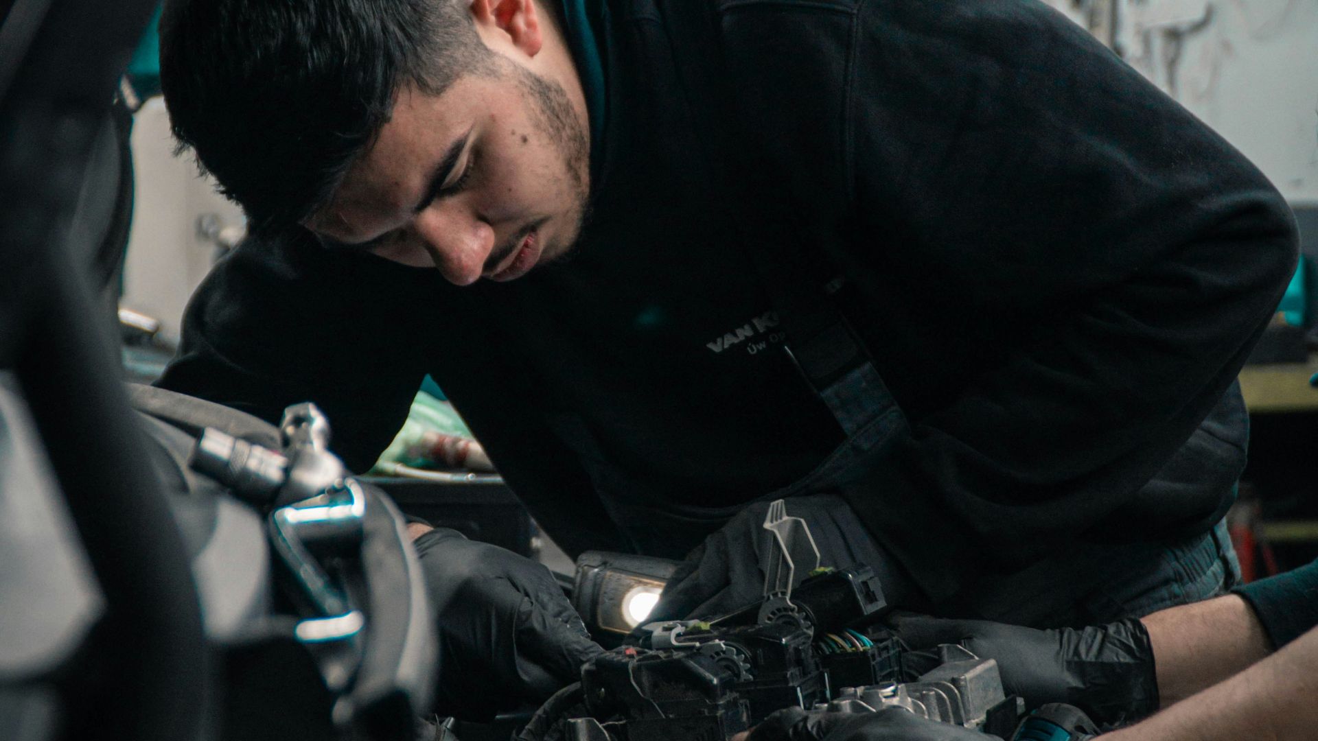 man in black jacket and blue denim jeans riding motorcycle