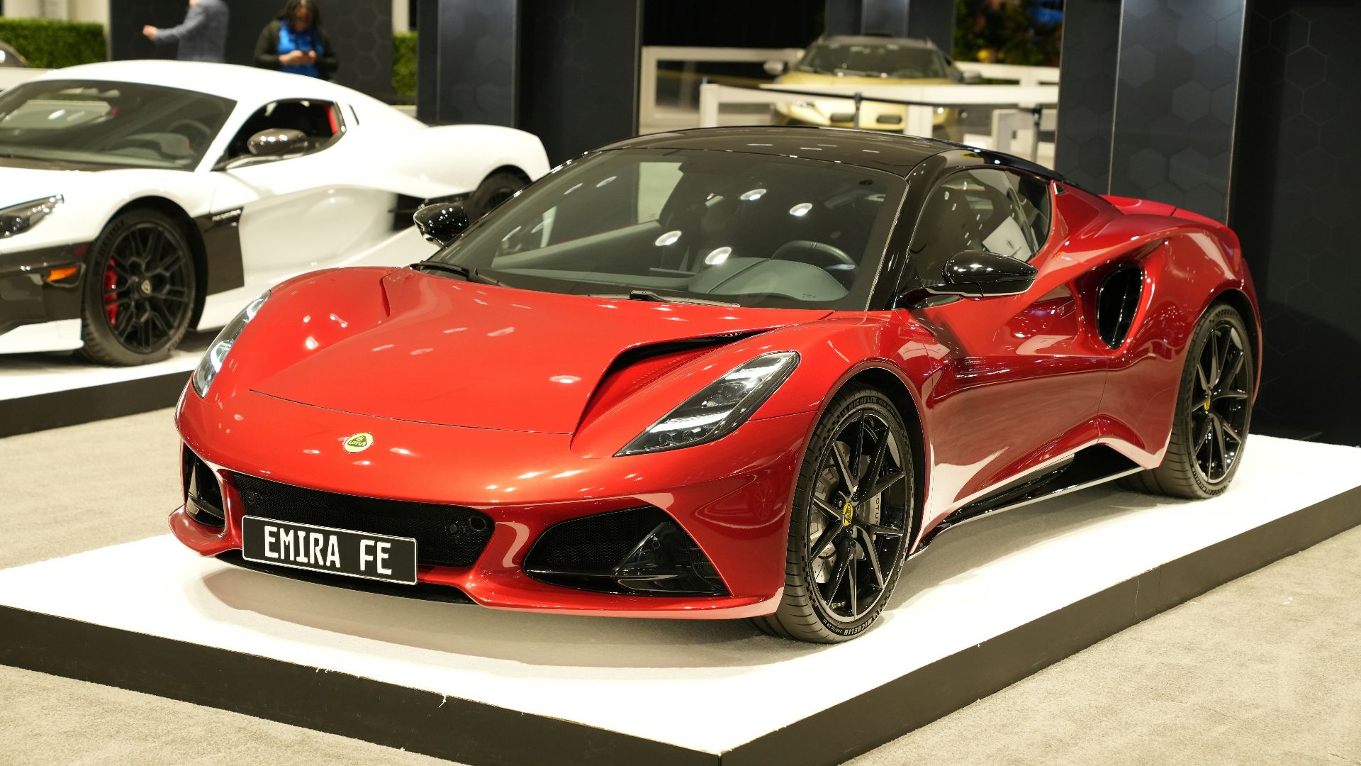 a red sports car on display at a car show