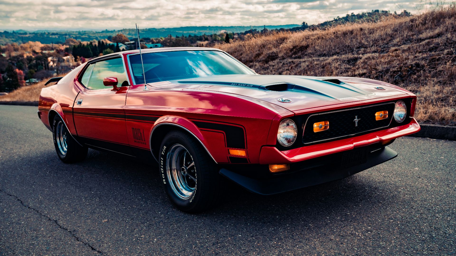 red chevrolet camaro on road during daytime