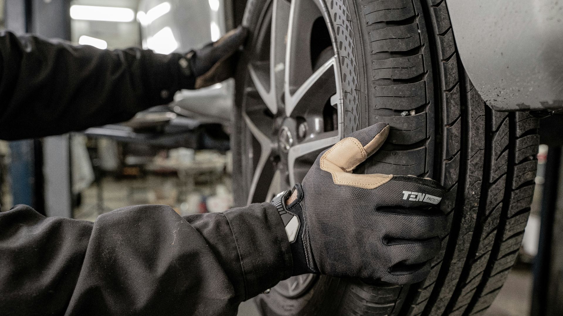 a man working on a tire in a garage