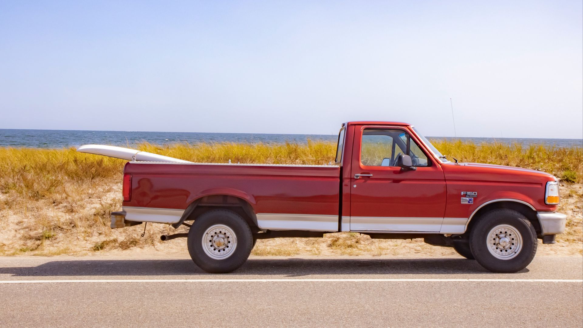 brown crew cab pickup truck on road during daytime