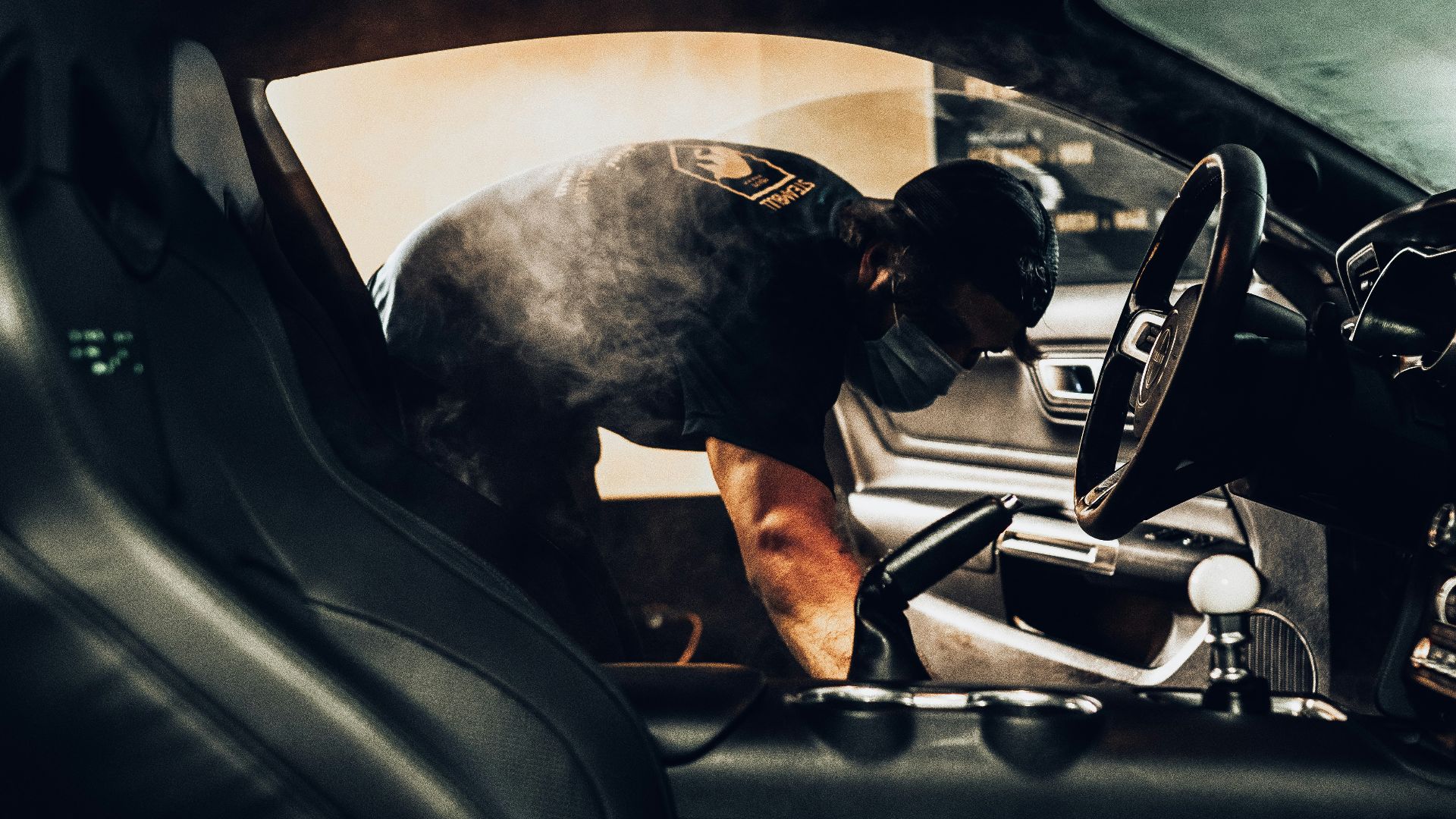 man in black t-shirt driving car