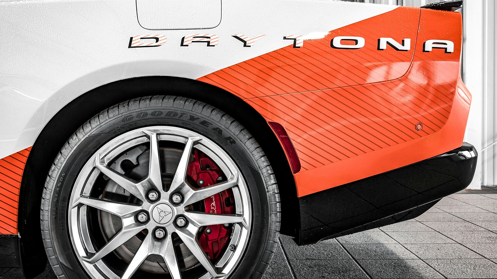 White and orange sports car with daytona branding