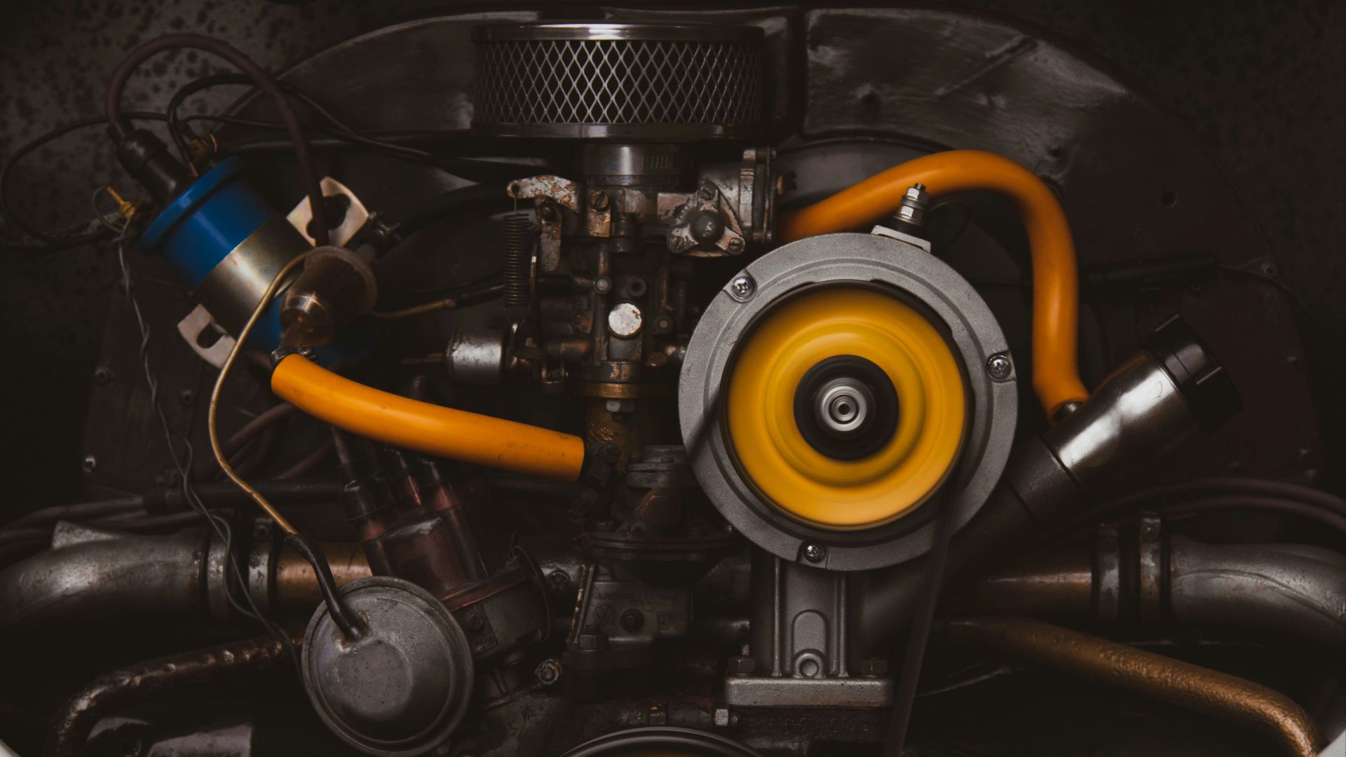 a close up of a car engine with yellow hoses