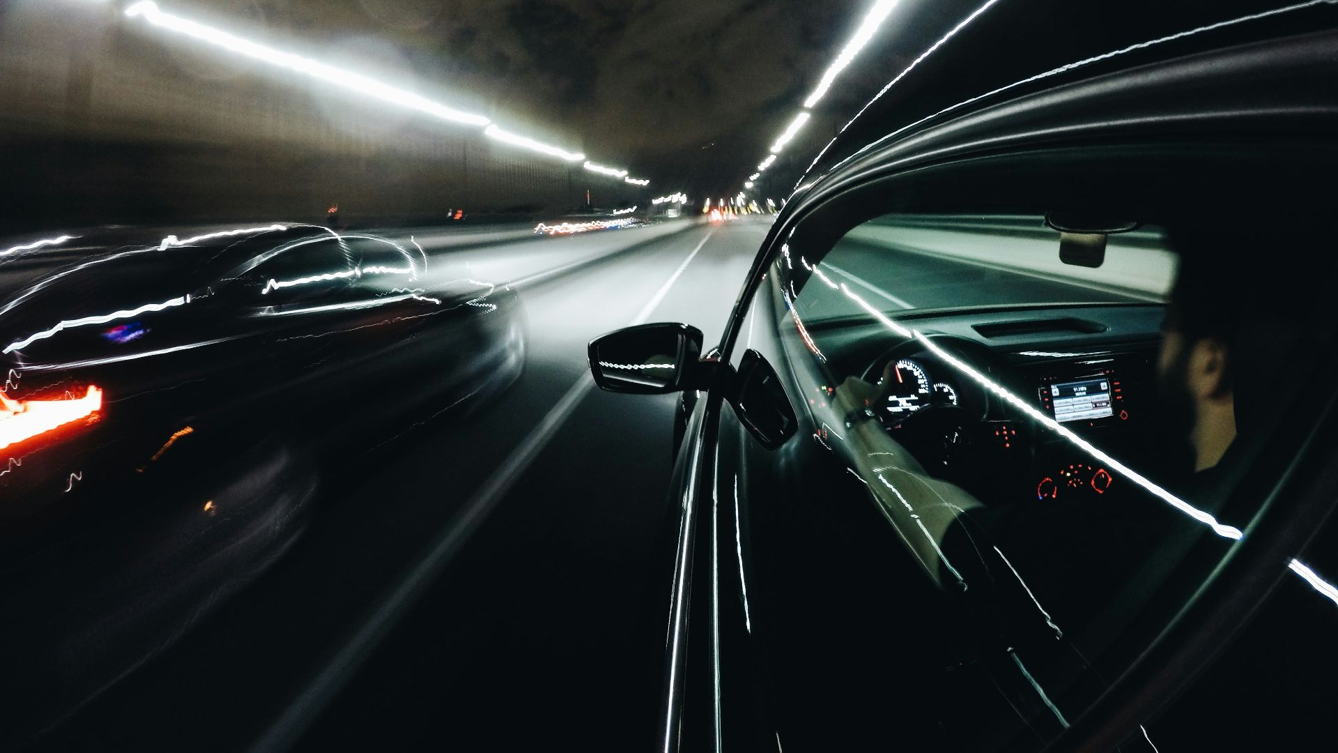 close-up photo of black car inside tunnel