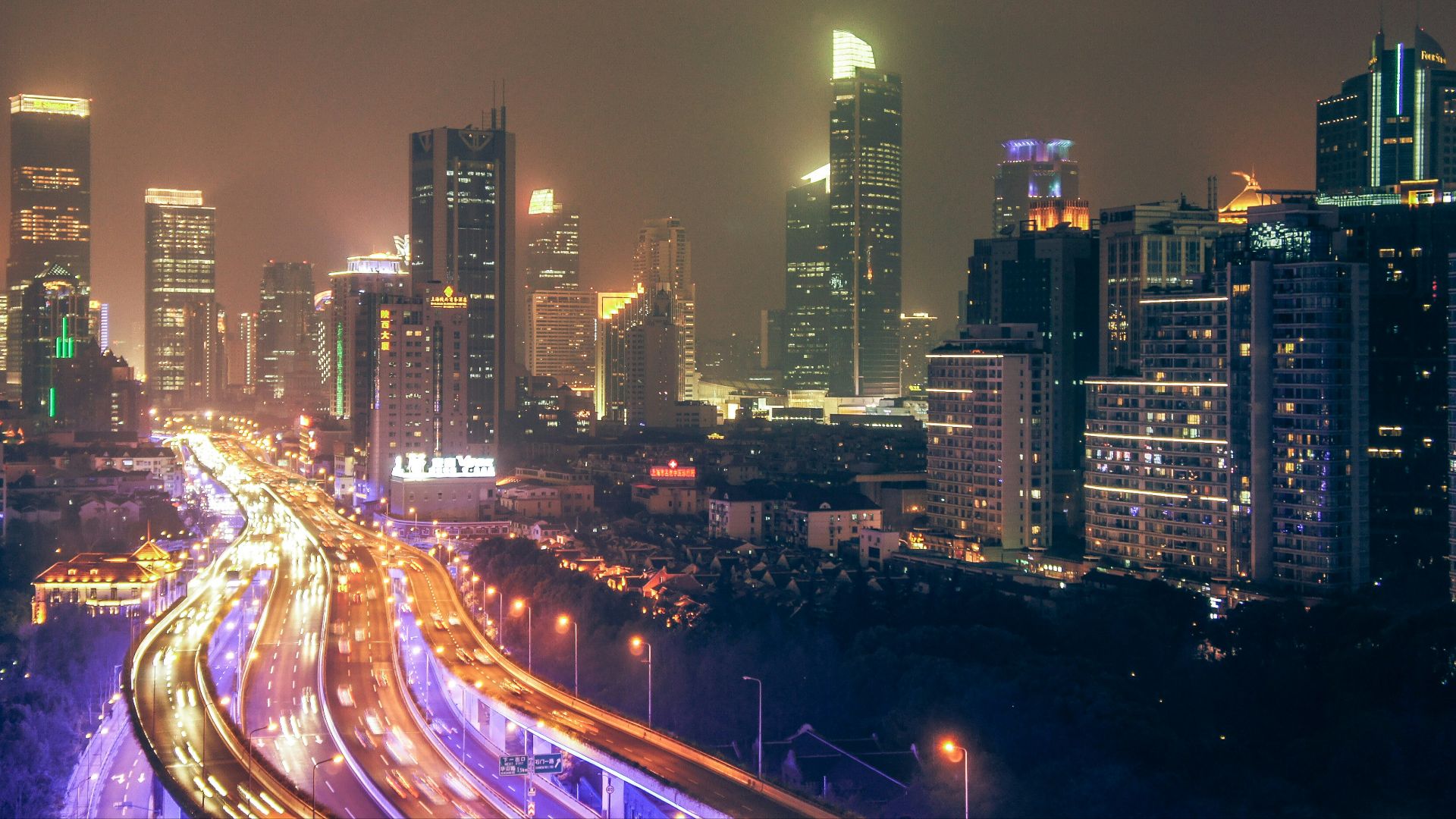 timelapse photography of building and roadway during nighttime