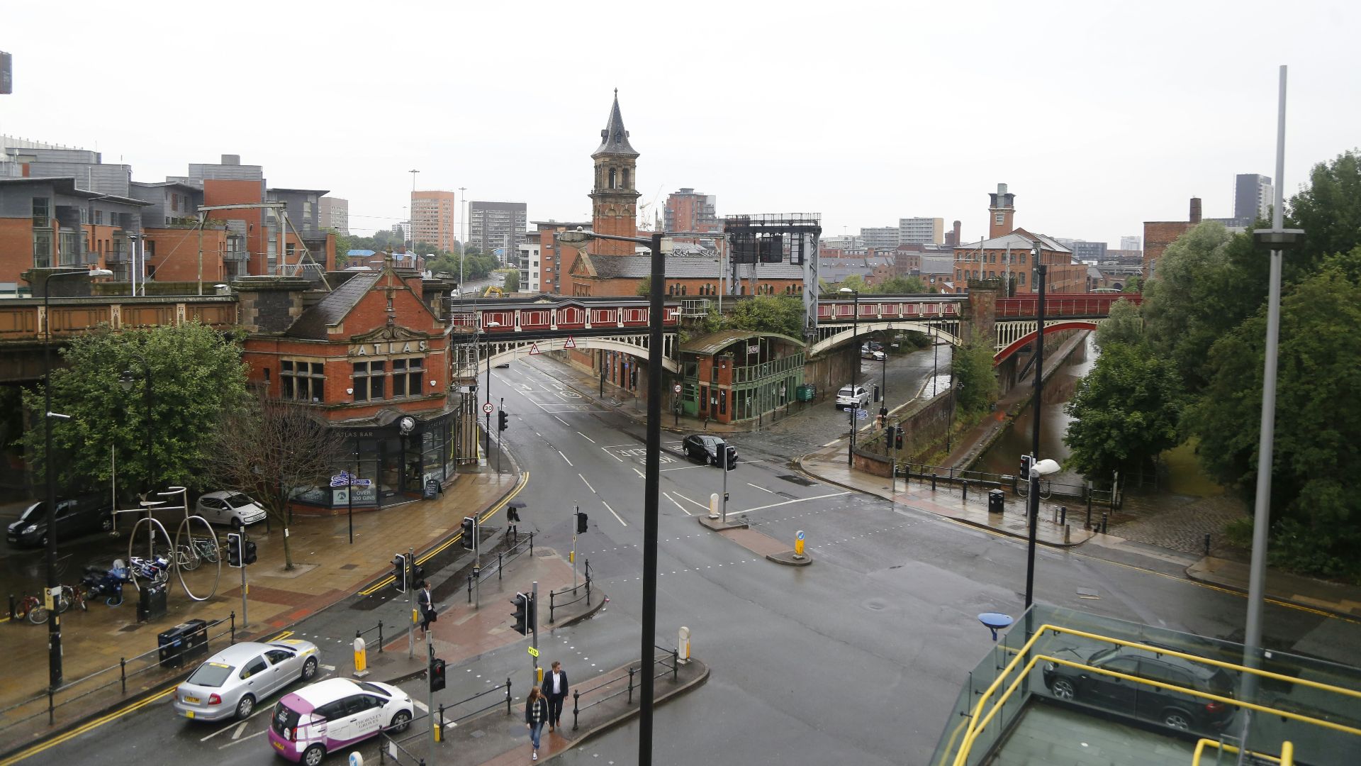 a view of a city street with a bridge in the background