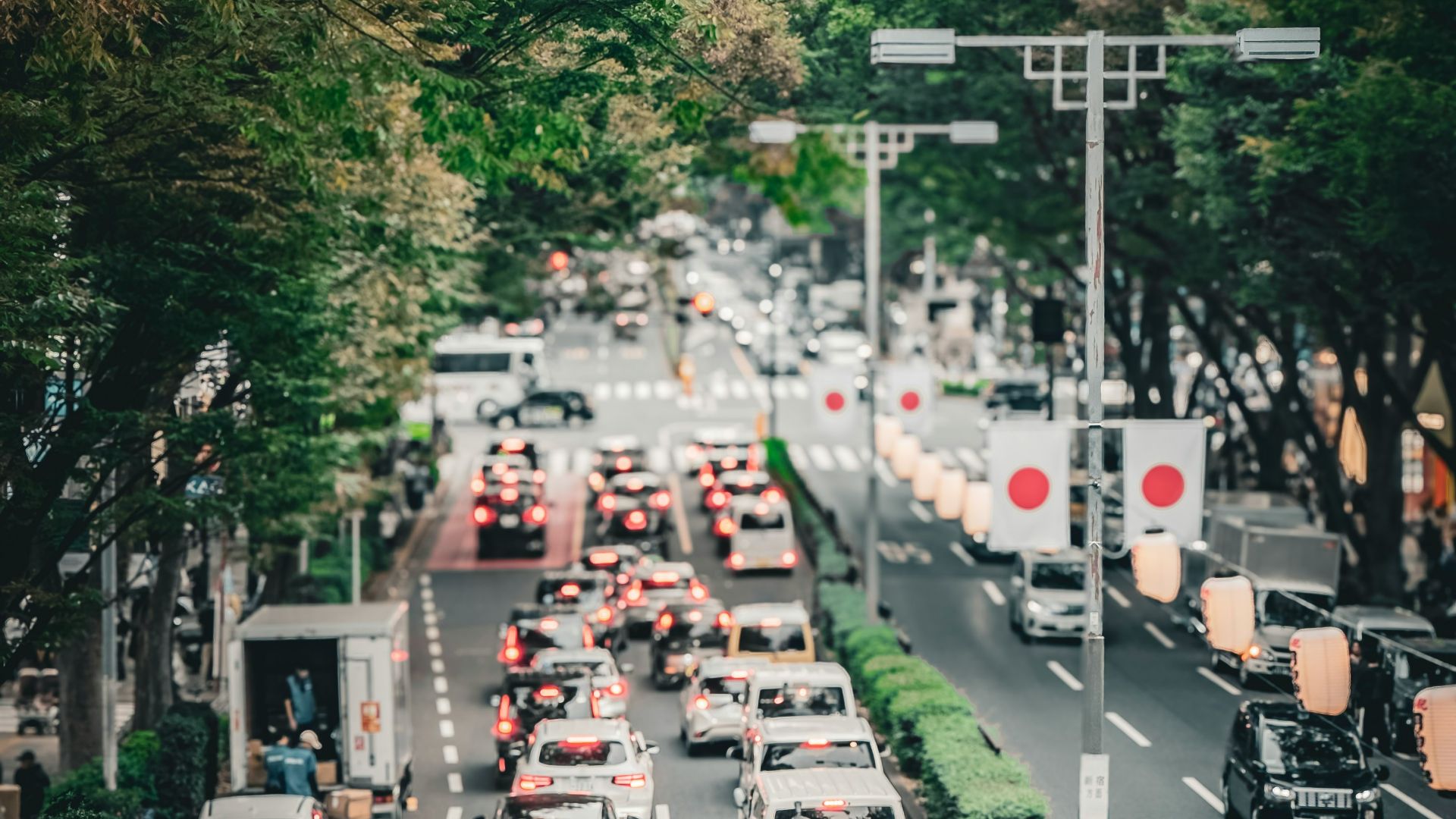 A street filled with lots of traffic next to trees