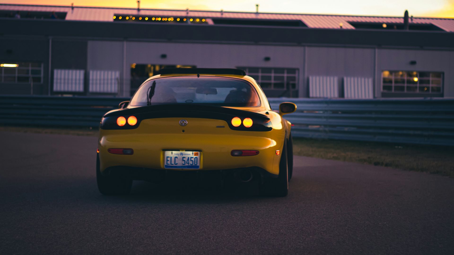 a yellow car on a road