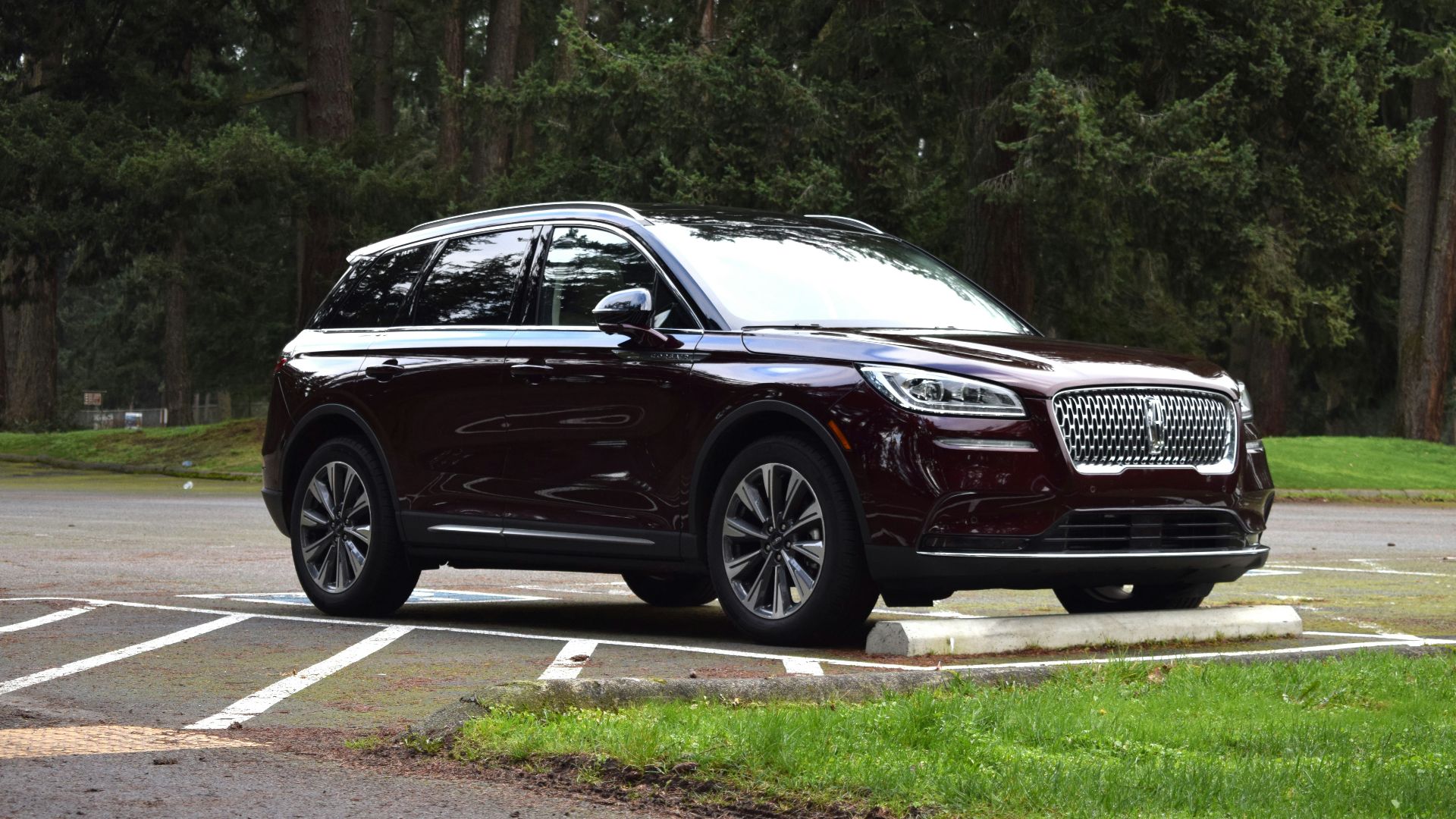 a maroon suv parked in a parking lot