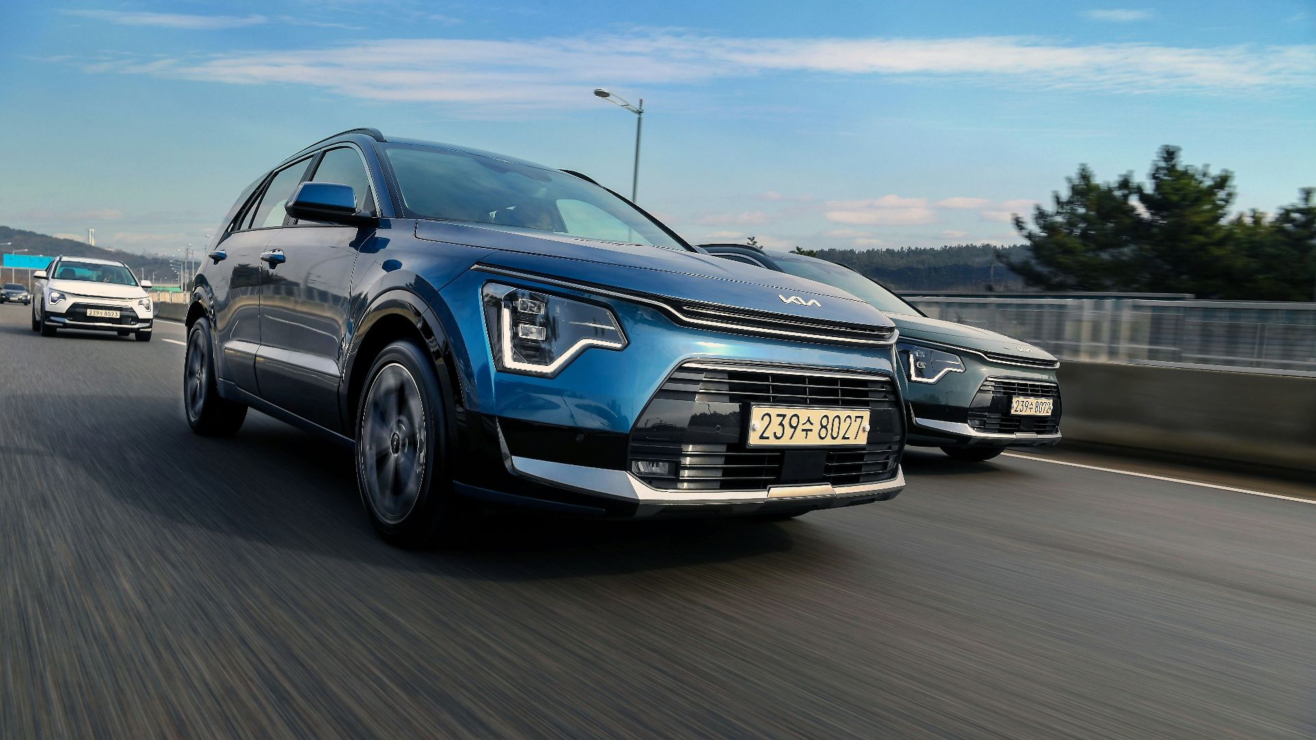 a couple of cars driving down a highway