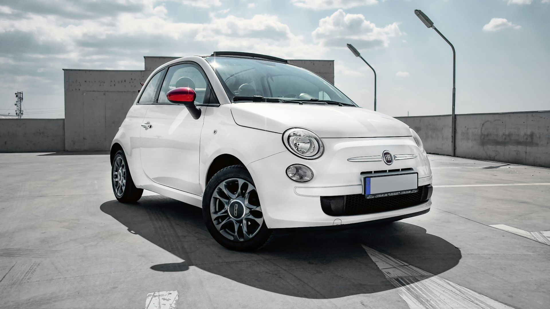 white 3-door hatchback on gray floor