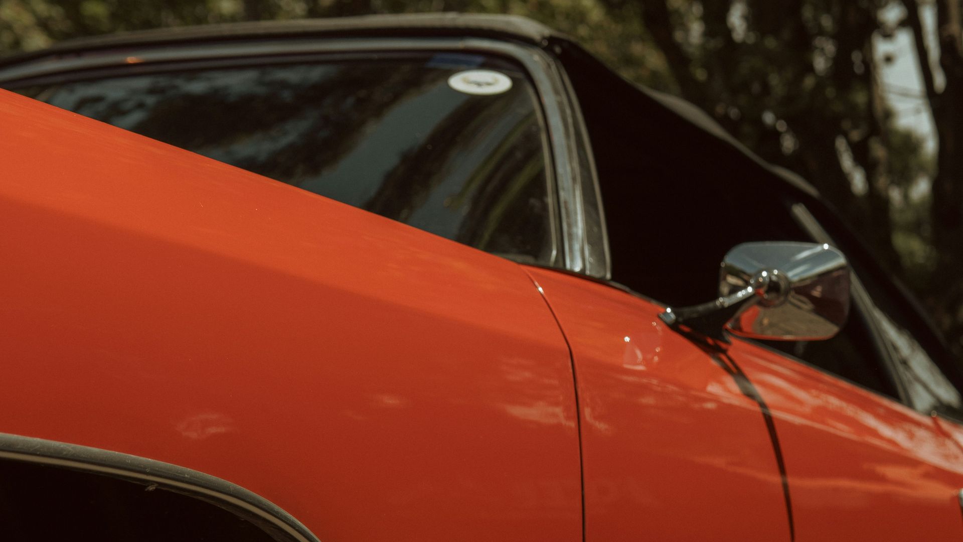 an orange car parked on the side of the road