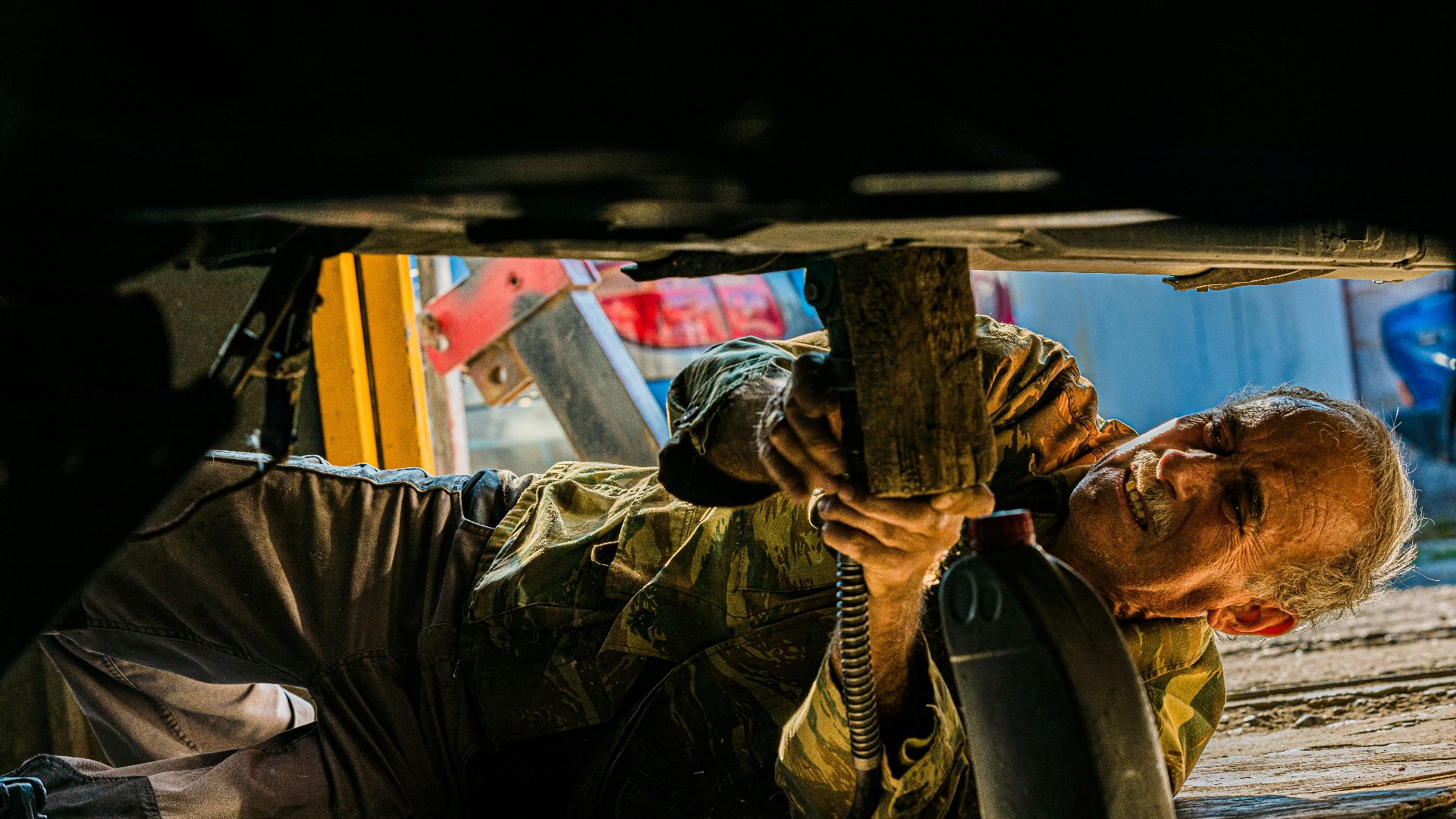 man hammering metal sheet