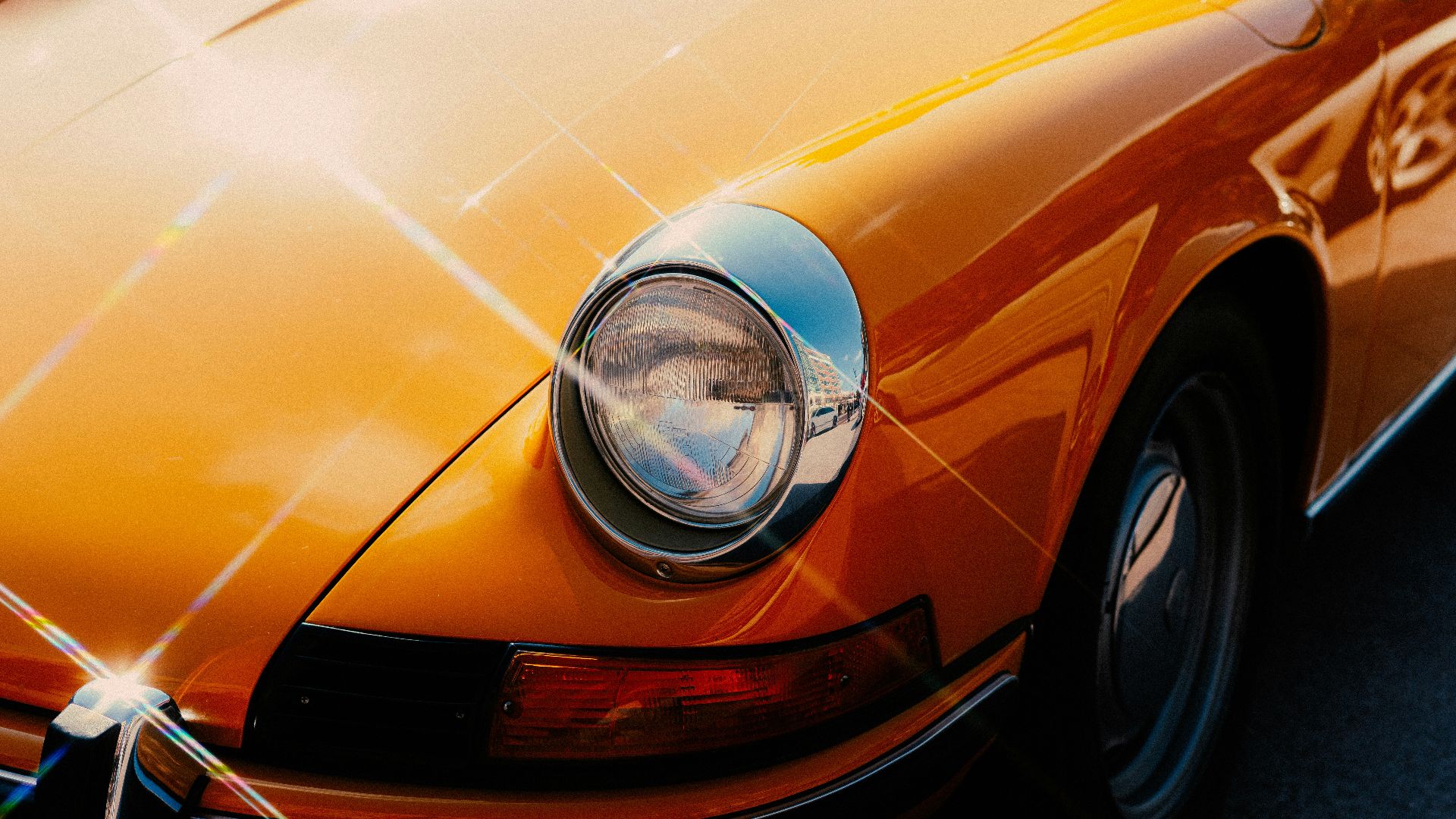 orange car with chrome headlight
