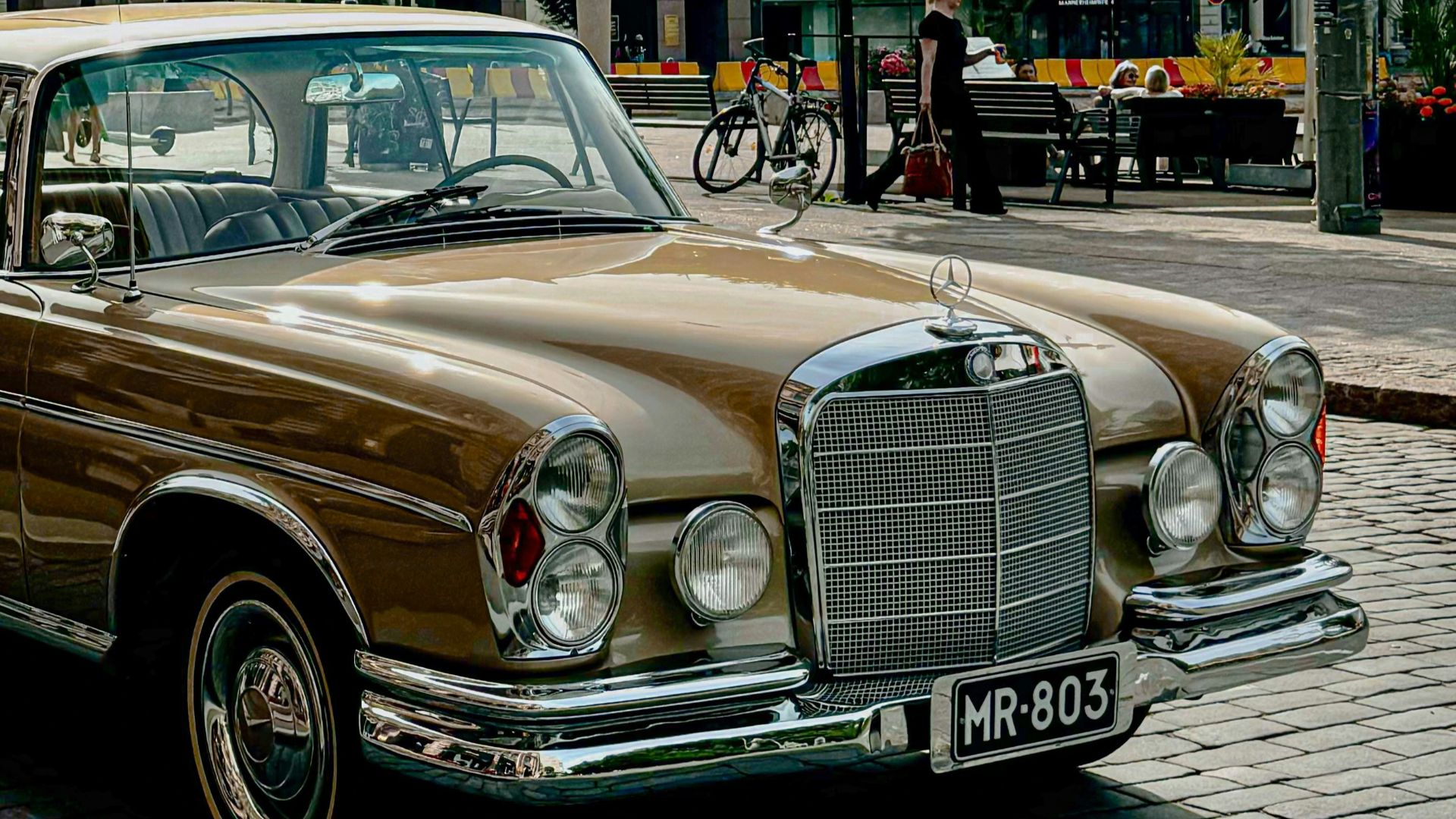 A brown car parked on the side of the road