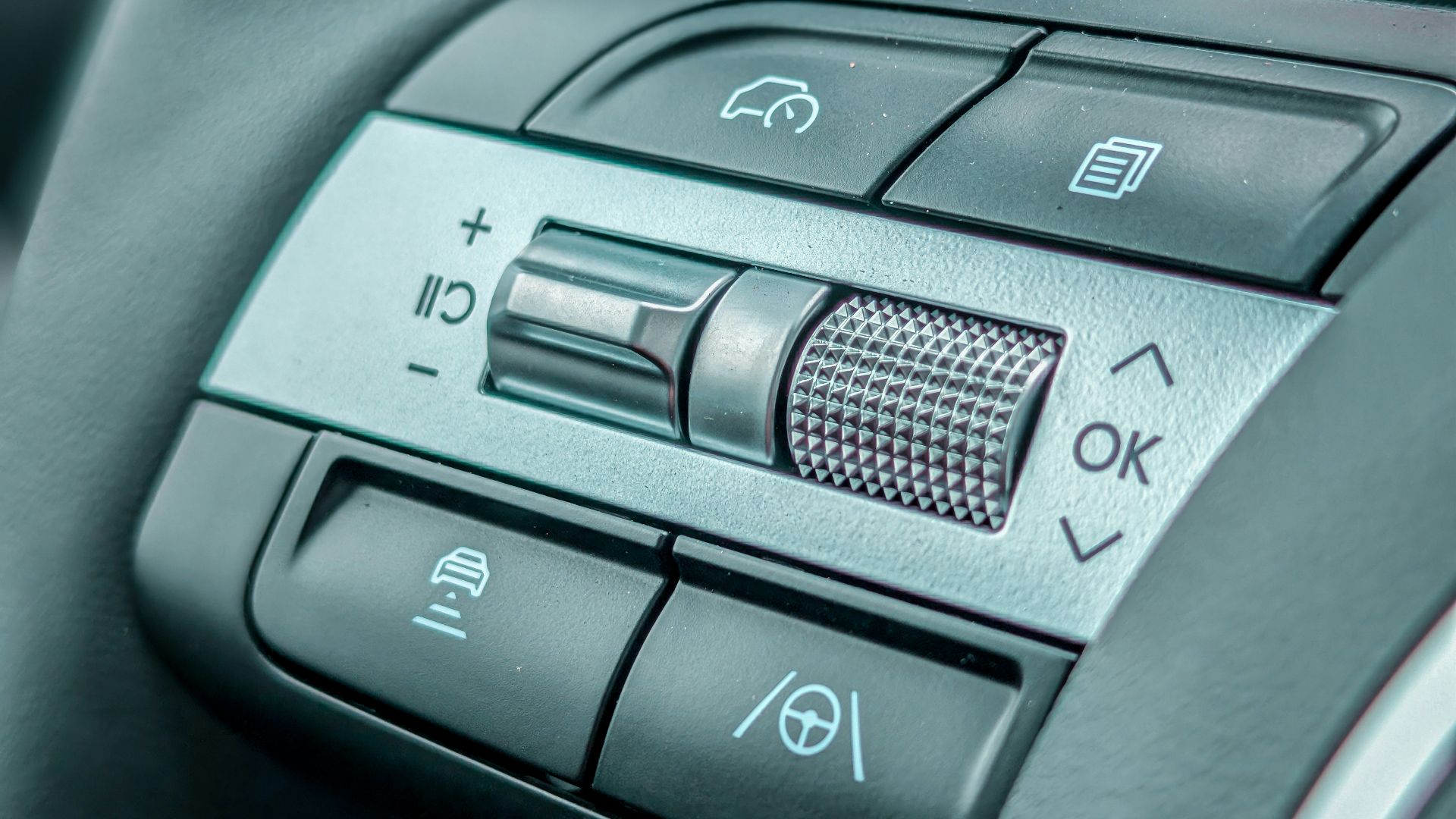 Close-up of a modern car steering wheel controls.