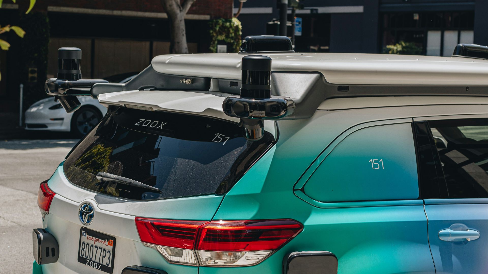 a car parked on the side of the road with a surfboard on top of