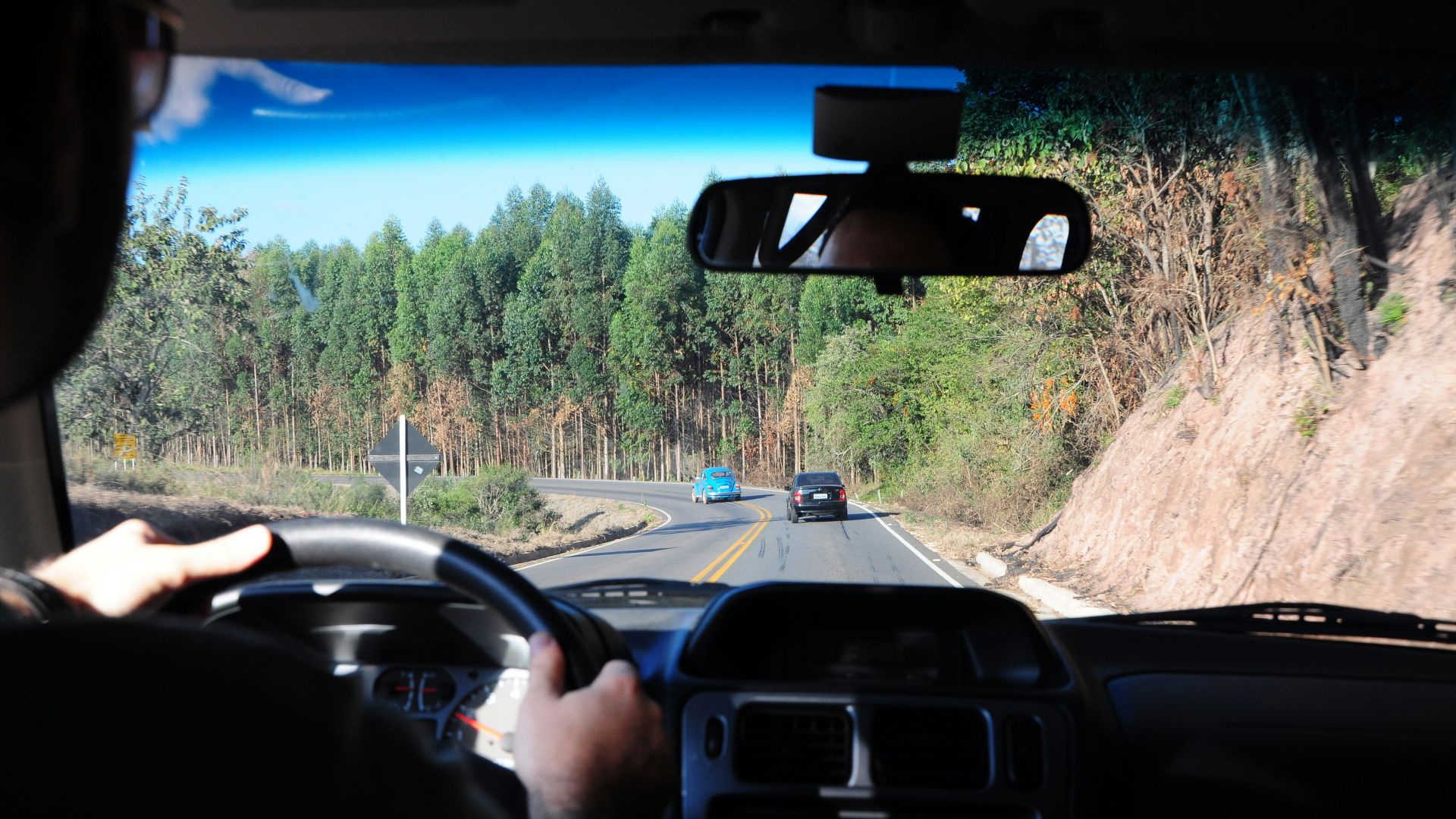 man driving a car on a road