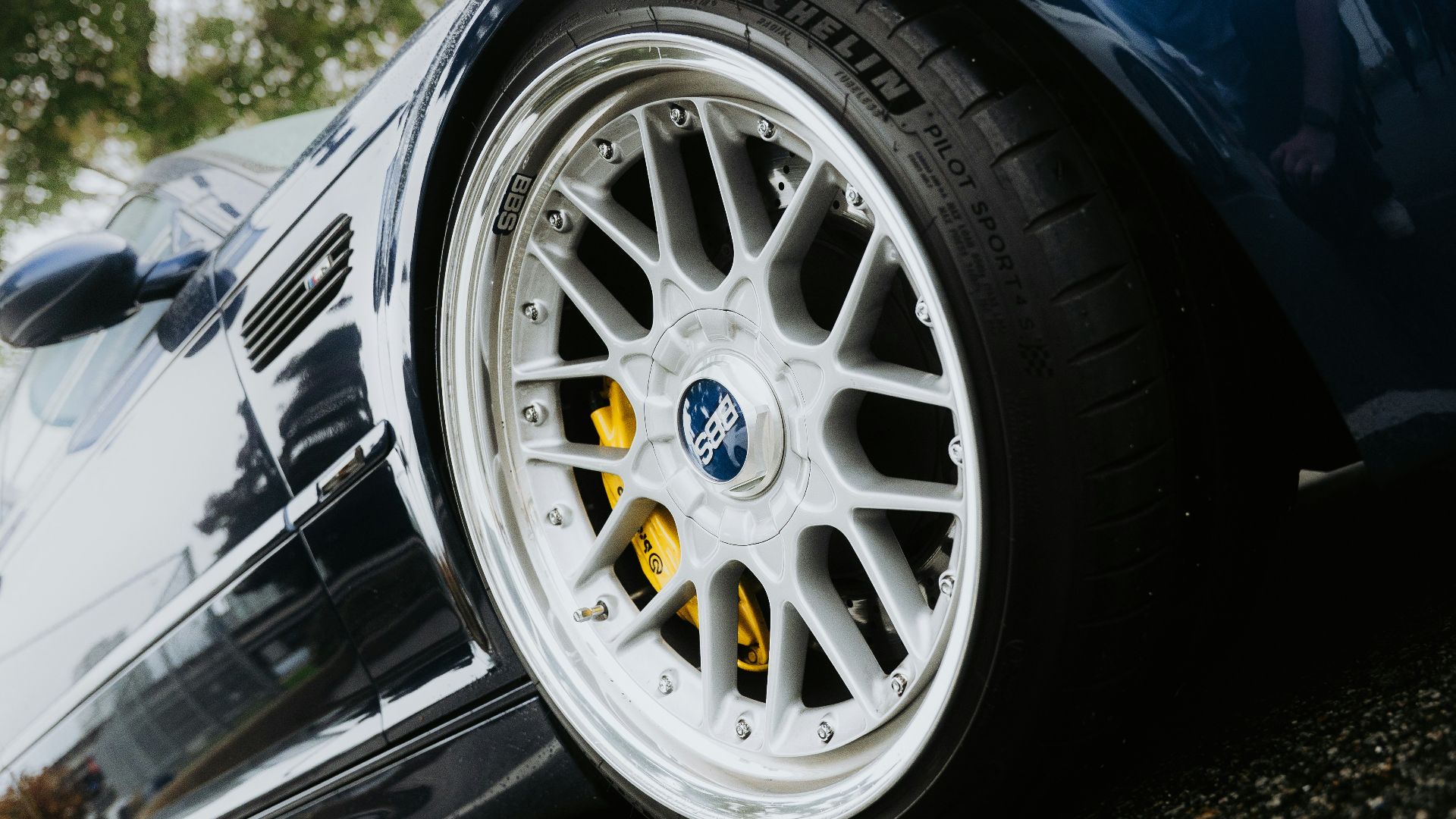 Close-up of a shiny blue car wheel and tire