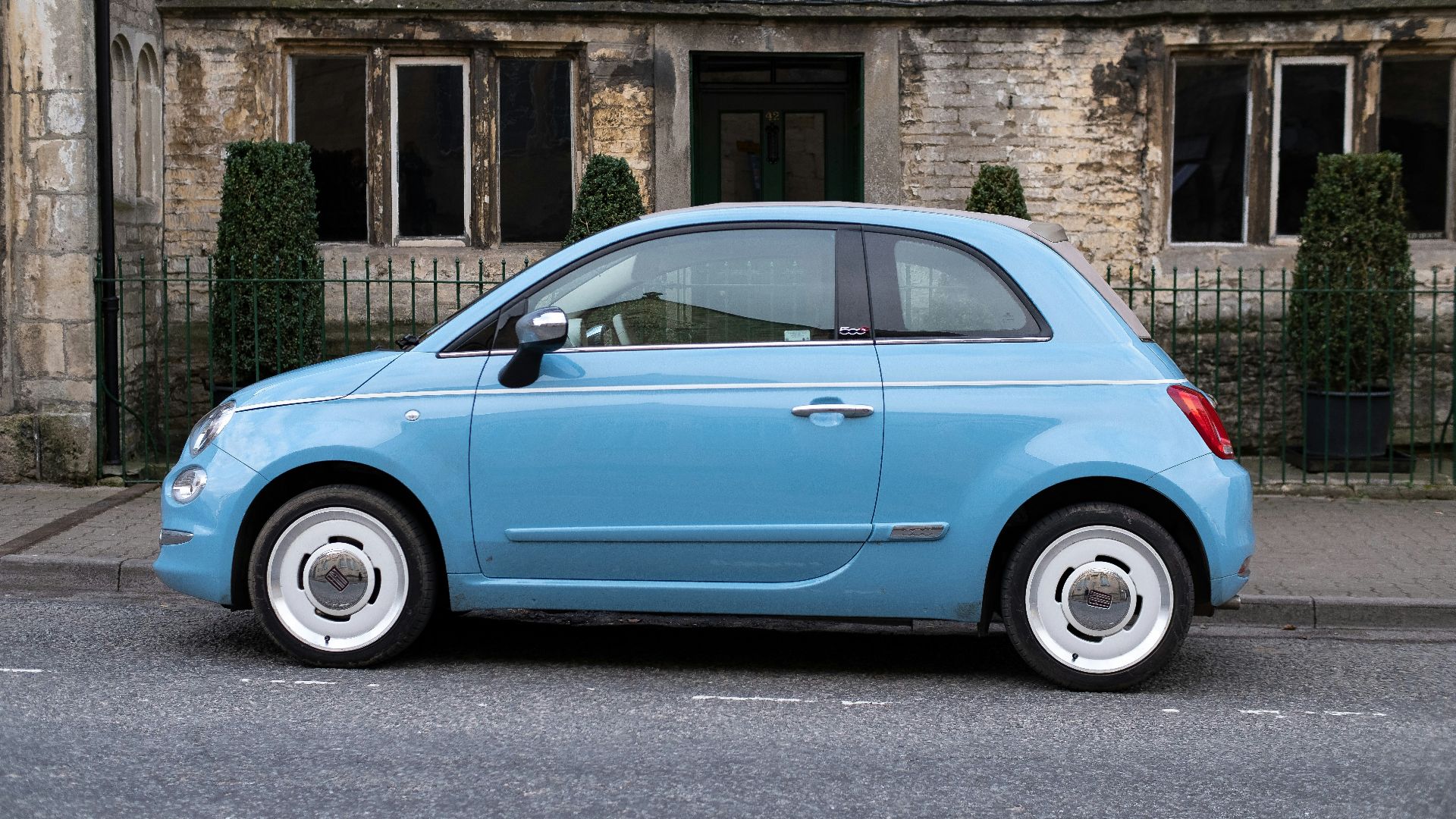 teal 3-door hatchback on road