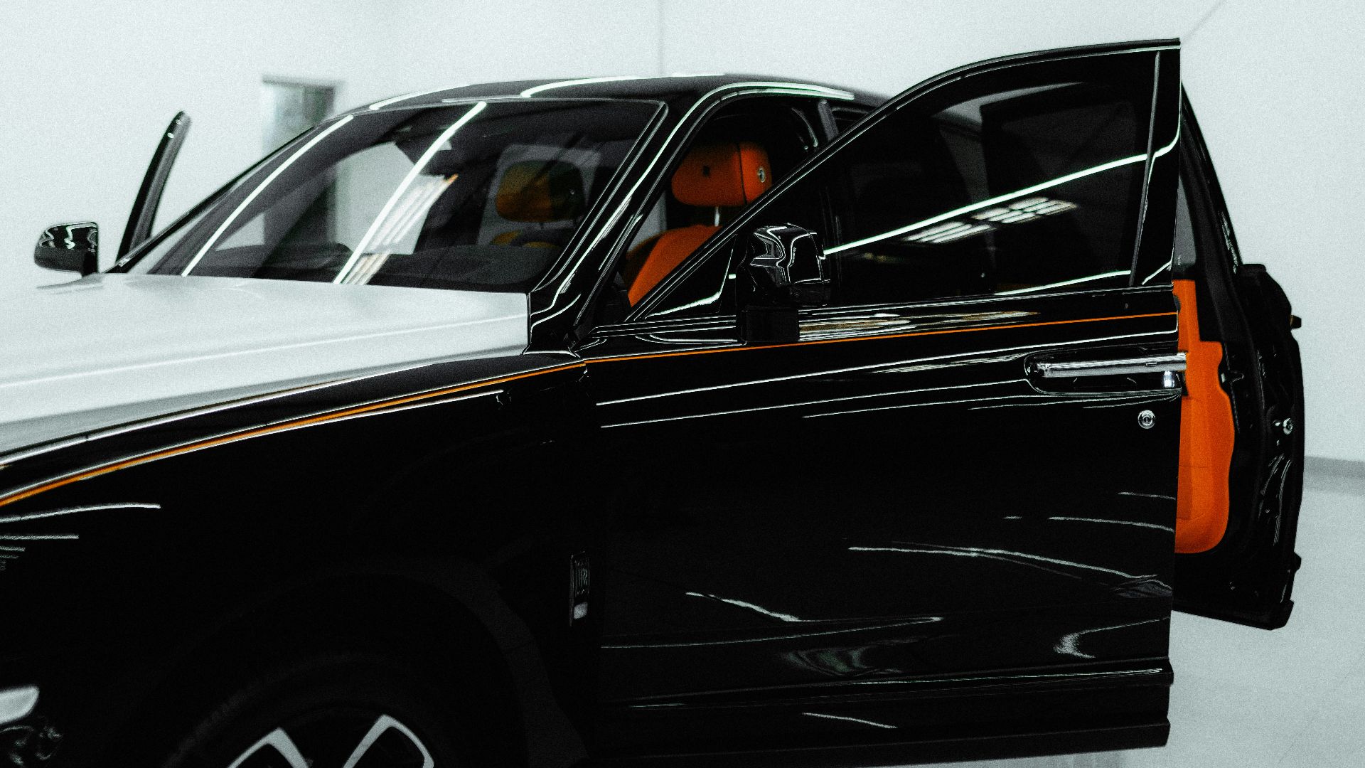 a black truck is parked in a white room