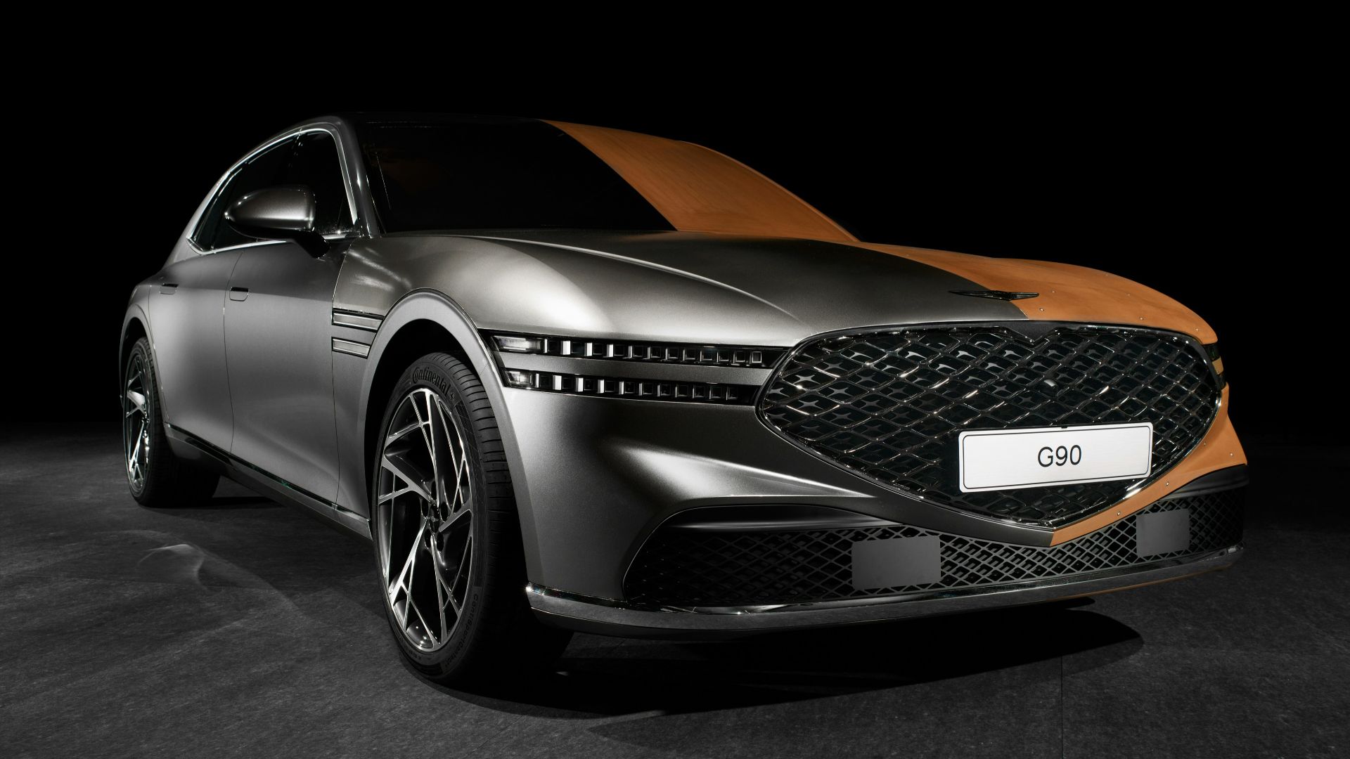 a silver and orange car in a dark room